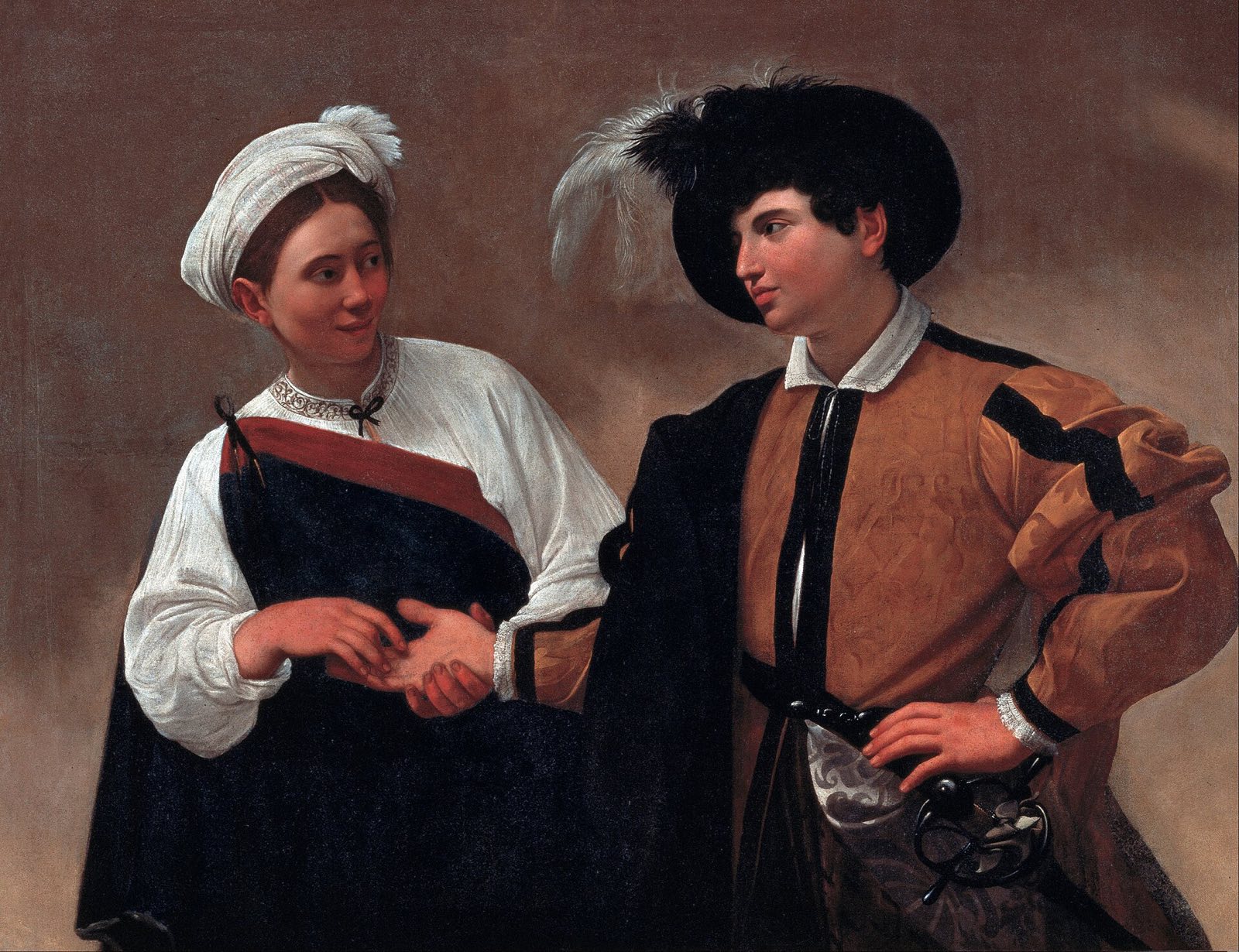 The Fortune Teller by Caravaggio: a young woman holds the hand of a well-dressed youth and looks him in the eye.