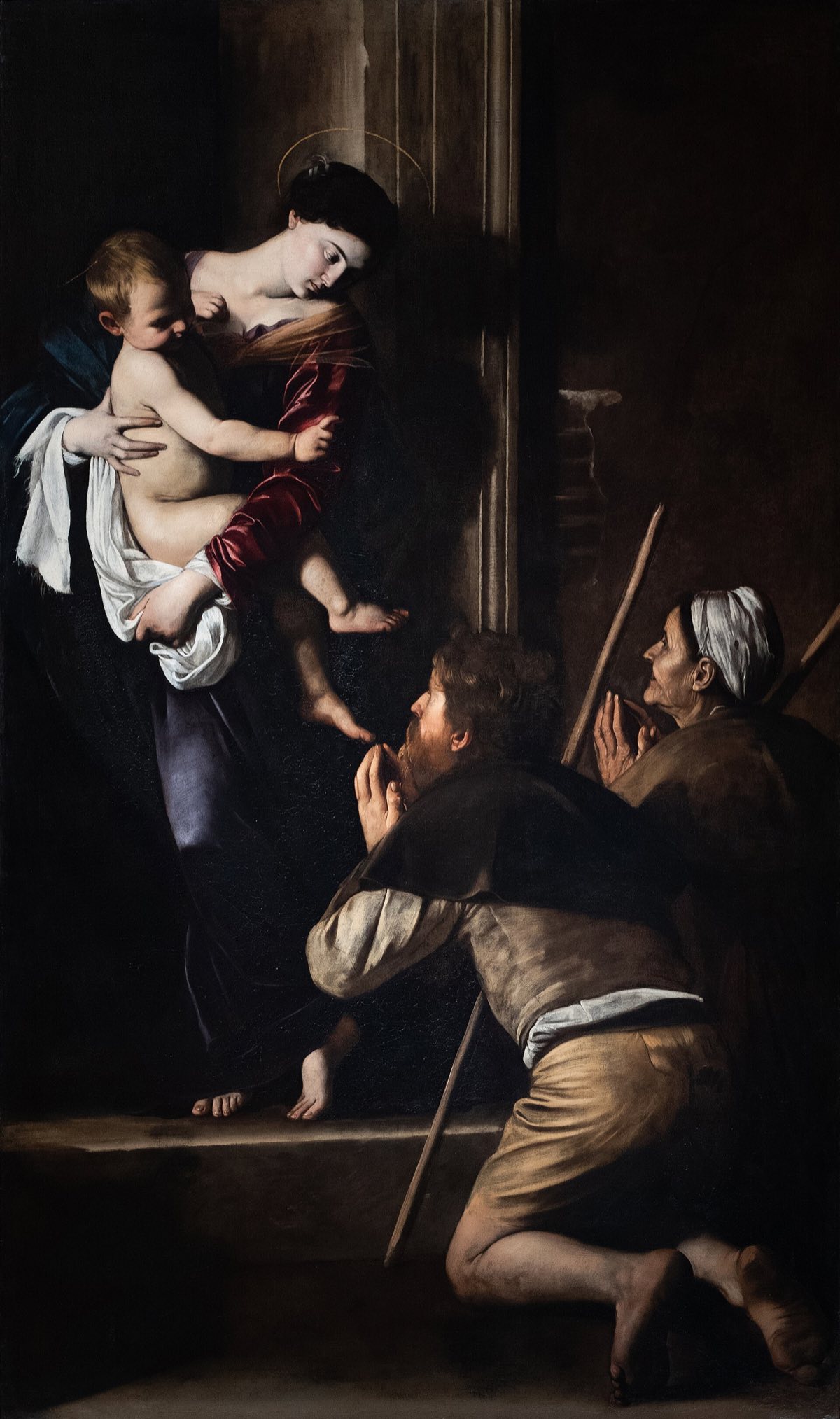 The Madonna of Loreto by Caravaggio: the Virgin with the child at a doorway, and two pilgrims kneeling before her.