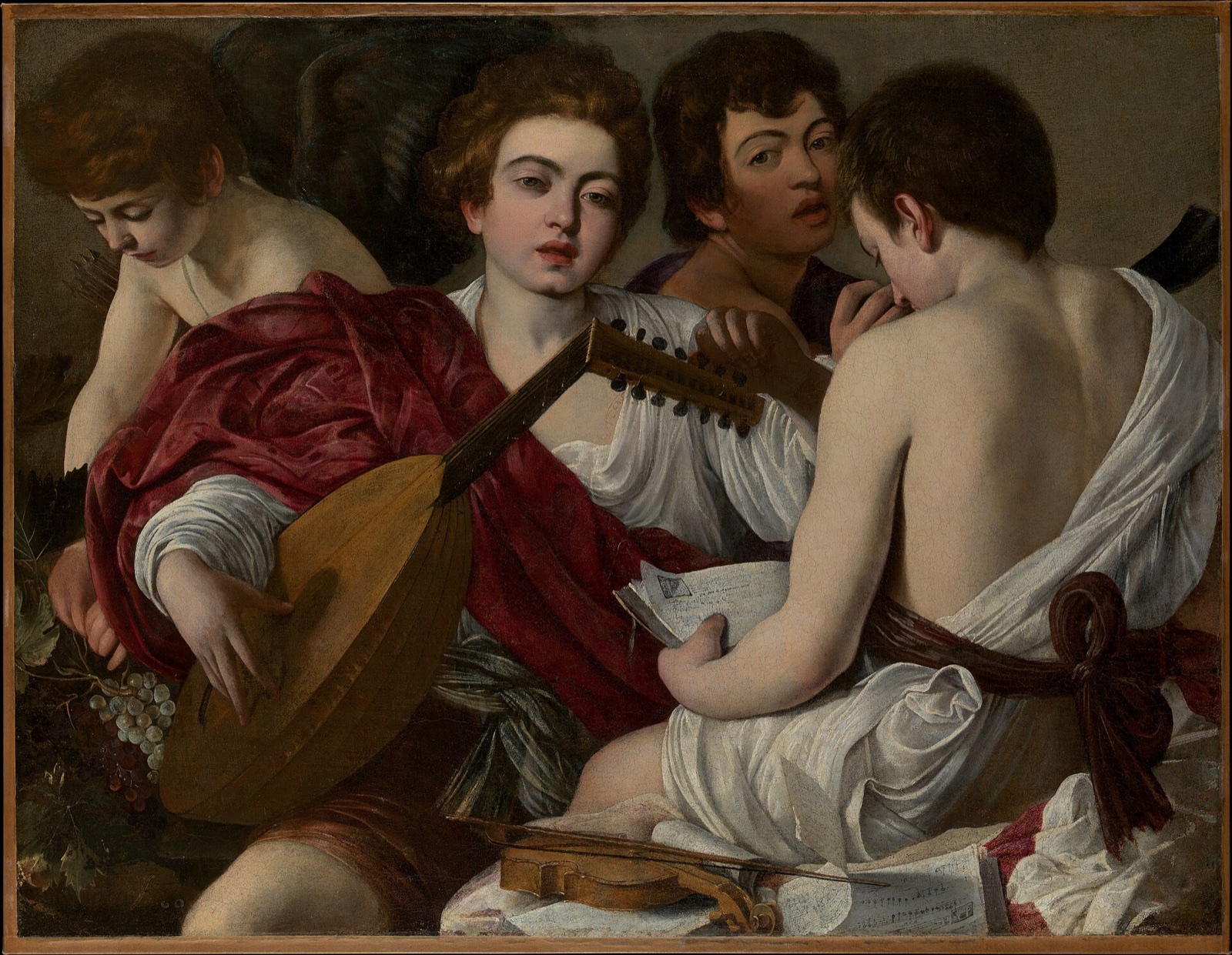 The Musicians, by Caravaggio: four boys in loose classical dress crowd together with a lute, a violin and sheets of music.