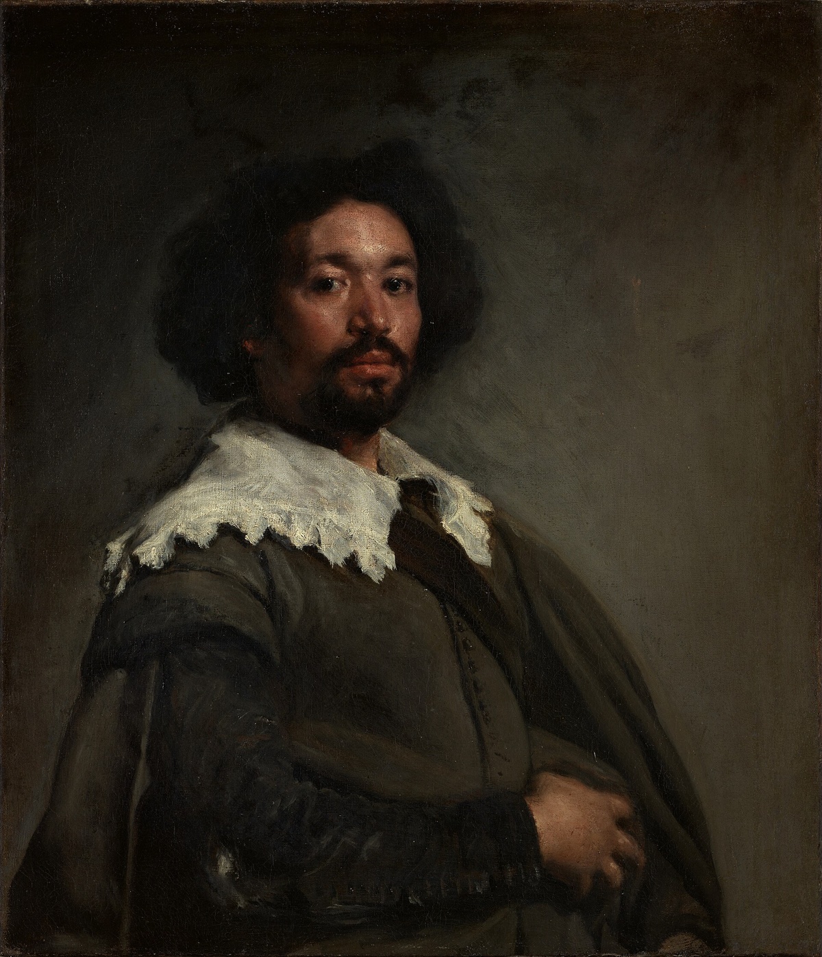 Juan de Pareja, by Velázquez: a man in a grey doublet and a wide lace collar looks straight at the viewer.