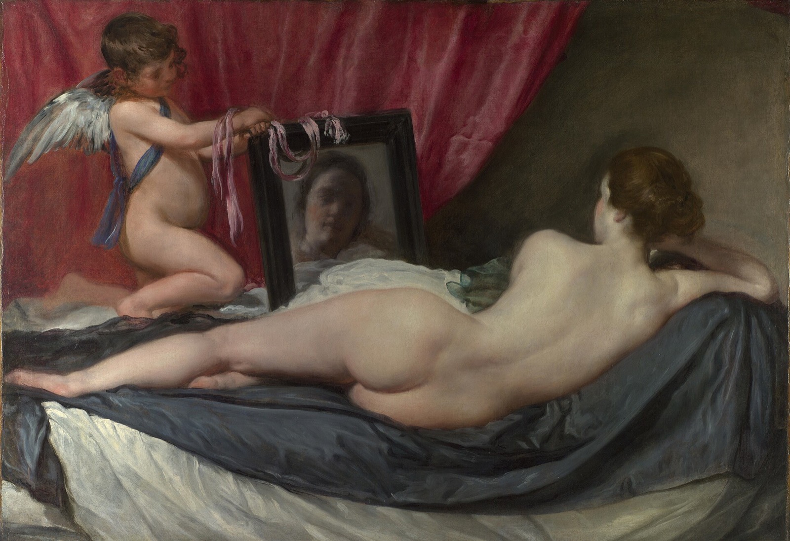 The Rokeby Venus, by Velázquez: Venus lies with her back to us while Cupid holds up a mirror.