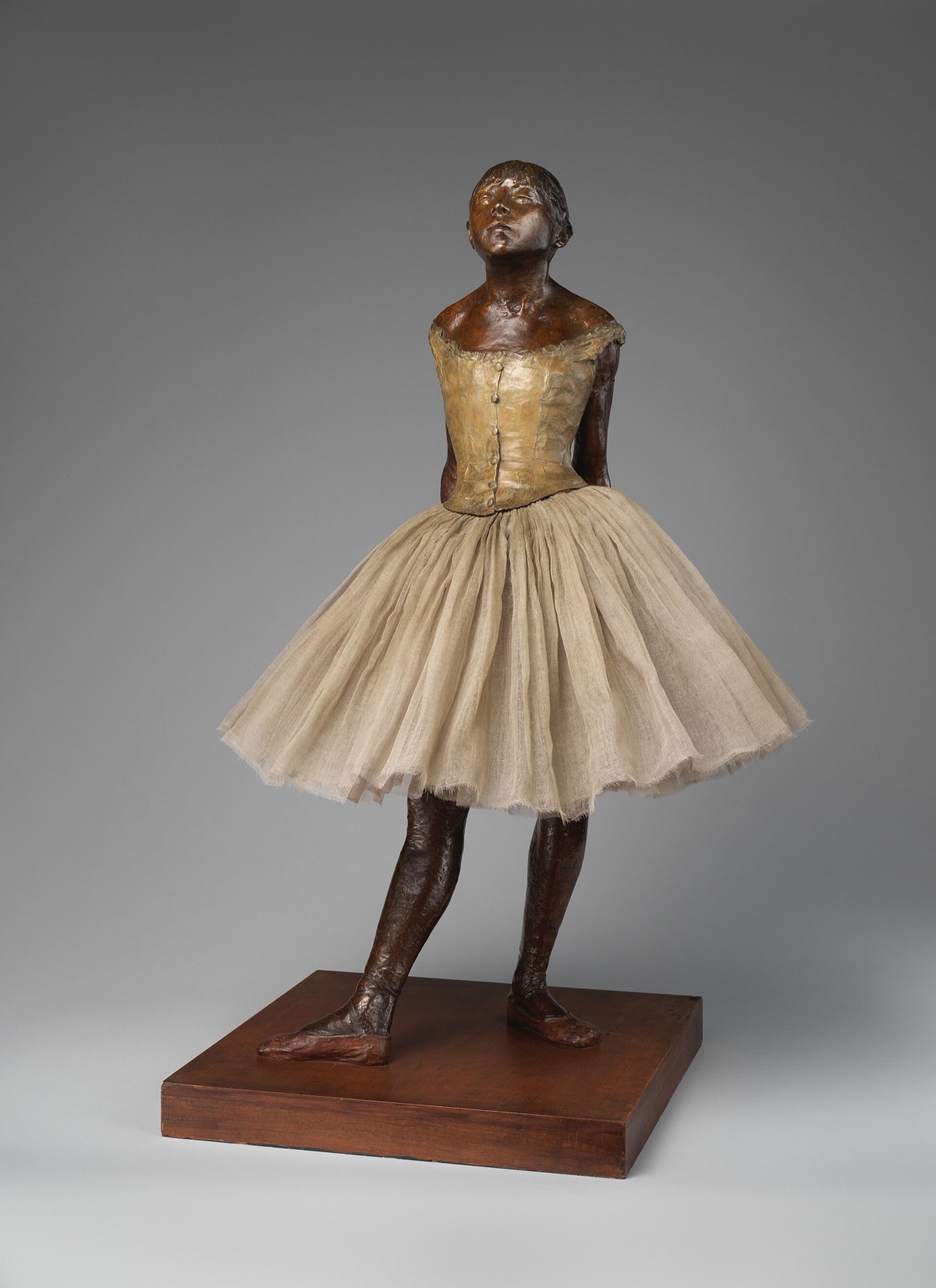 The Little Fourteen-Year-Old Dancer, by Degas: a bronze figure of a young dancer with her chin raised, in a cloth skirt and a satin hair ribbon.