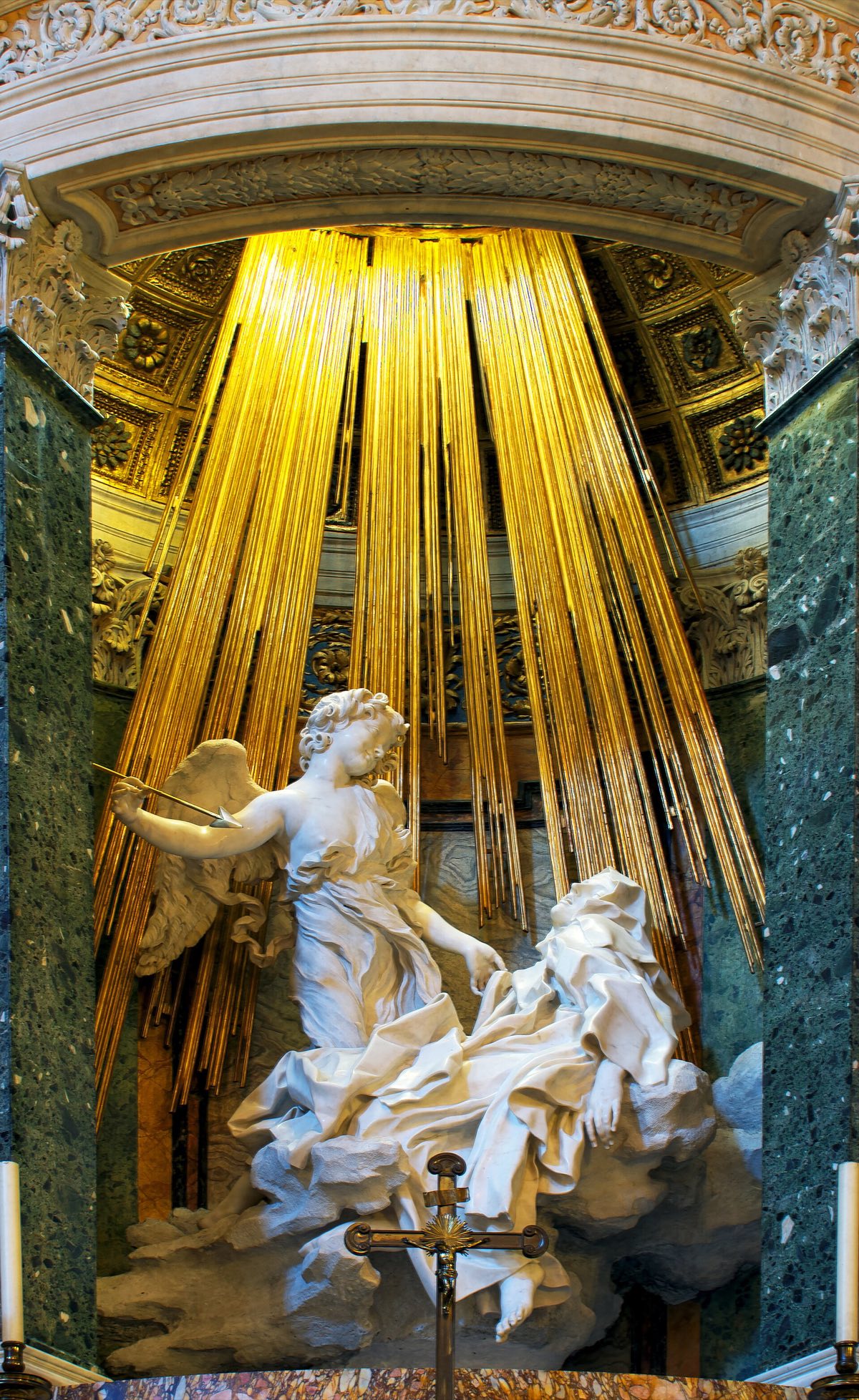 The Ecstasy of St Teresa by Bernini: the saint swooning on a cloud before an angel with an arrow, under gilded rays.