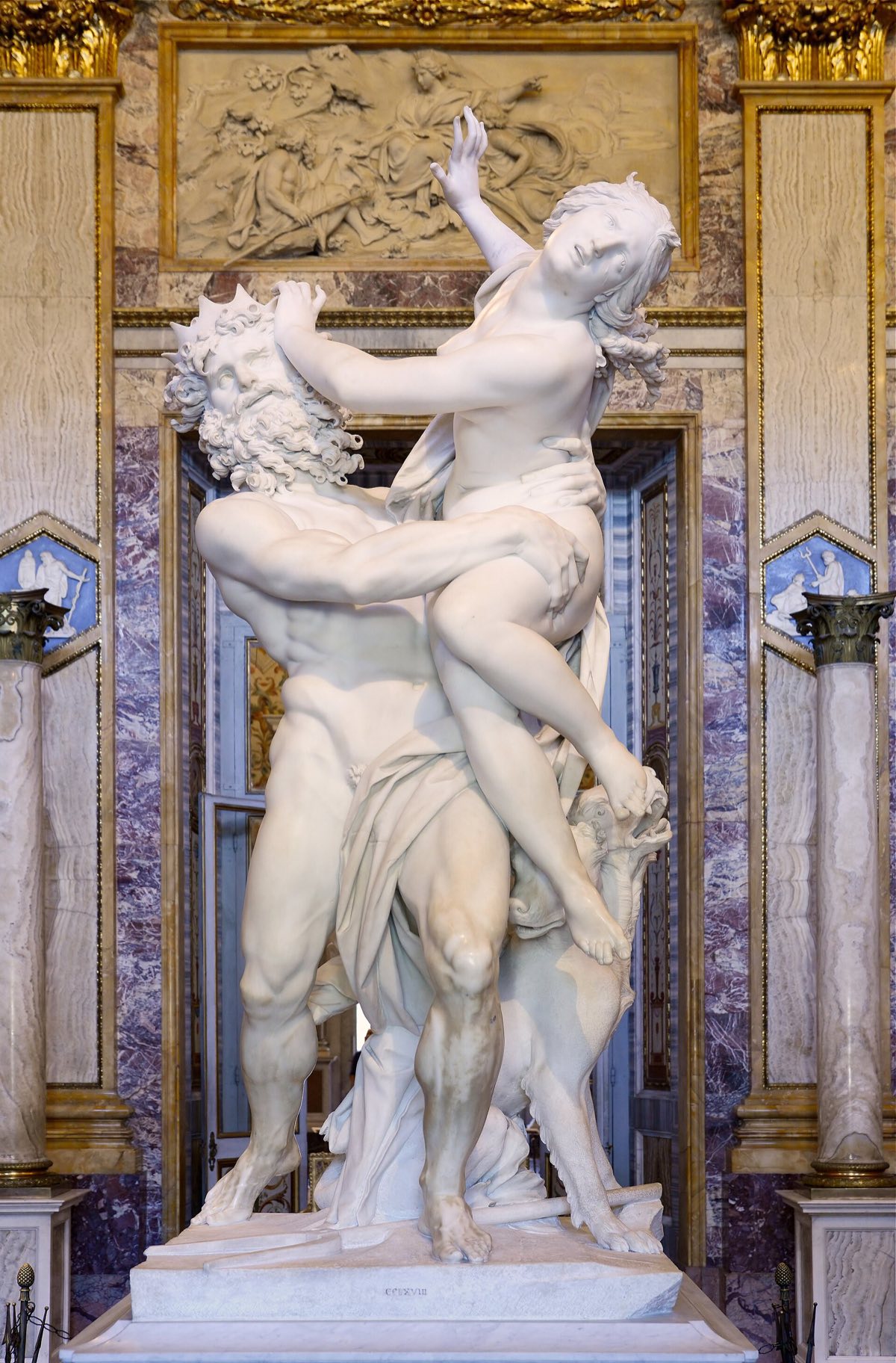 The Rape of Proserpina by Bernini: Pluto lifts the struggling Proserpina, his fingers pressing into her thigh.