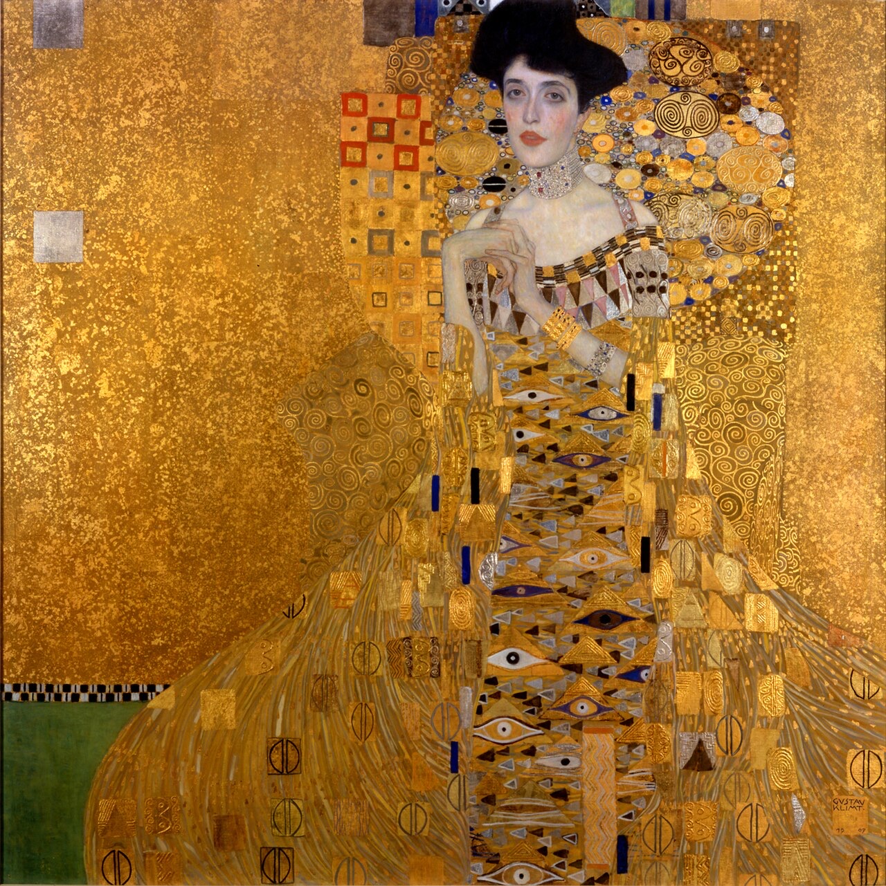 Portrait of Adele Bloch-Bauer I, by Klimt: a woman's face, shoulders and clasped hands emerge from a dress and a ground of patterned gold.