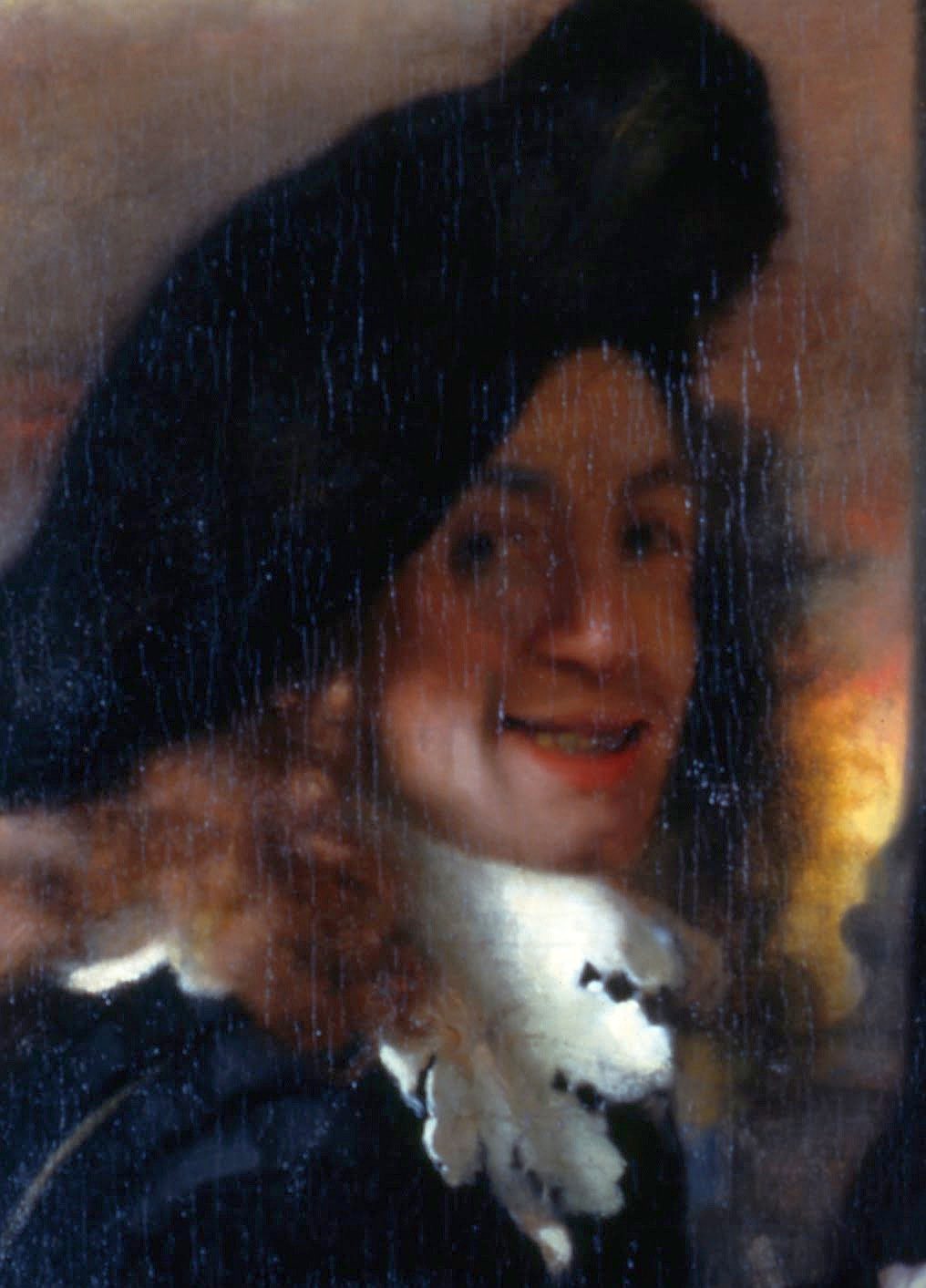 A detail of a painting by Vermeer, a smiling man in a beret, thought to be the painter himself.