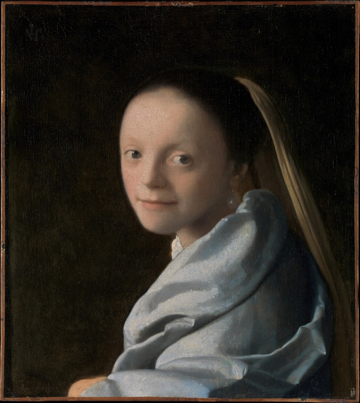 Study of a Young Woman, by Vermeer: a girl with a wide pale face looks over her shoulder against a black ground.