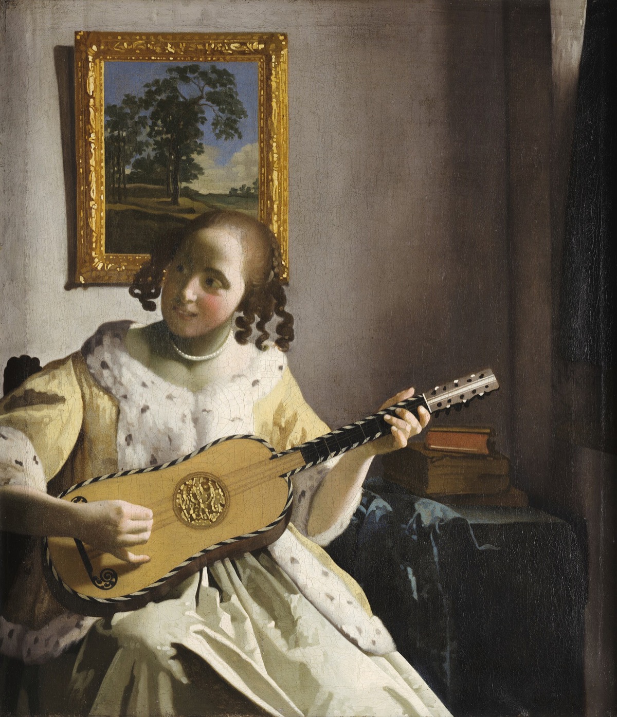The Guitar Player, by Vermeer: a girl with a guitar turns, smiling, towards someone out of the picture.