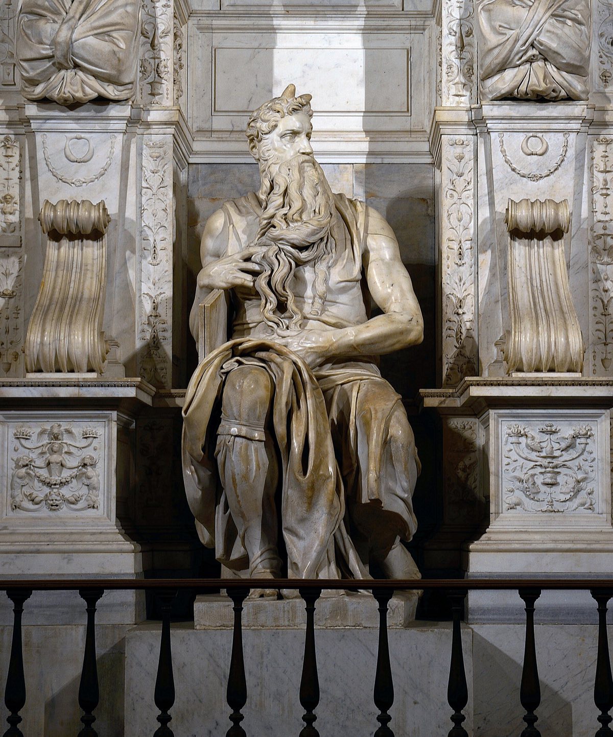 Michelangelo's Moses in San Pietro in Vincoli: the seated prophet with the tablets under his arm and a long beard.