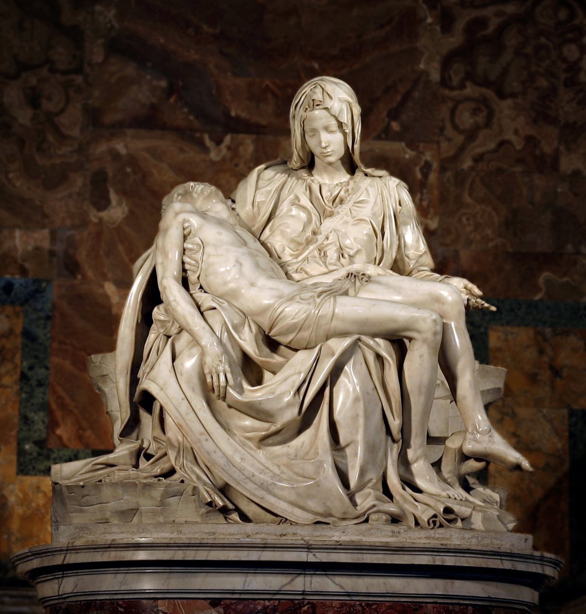 Michelangelo's Pietà in St Peter's Basilica: Mary holding the dead Christ across her lap, in white marble.