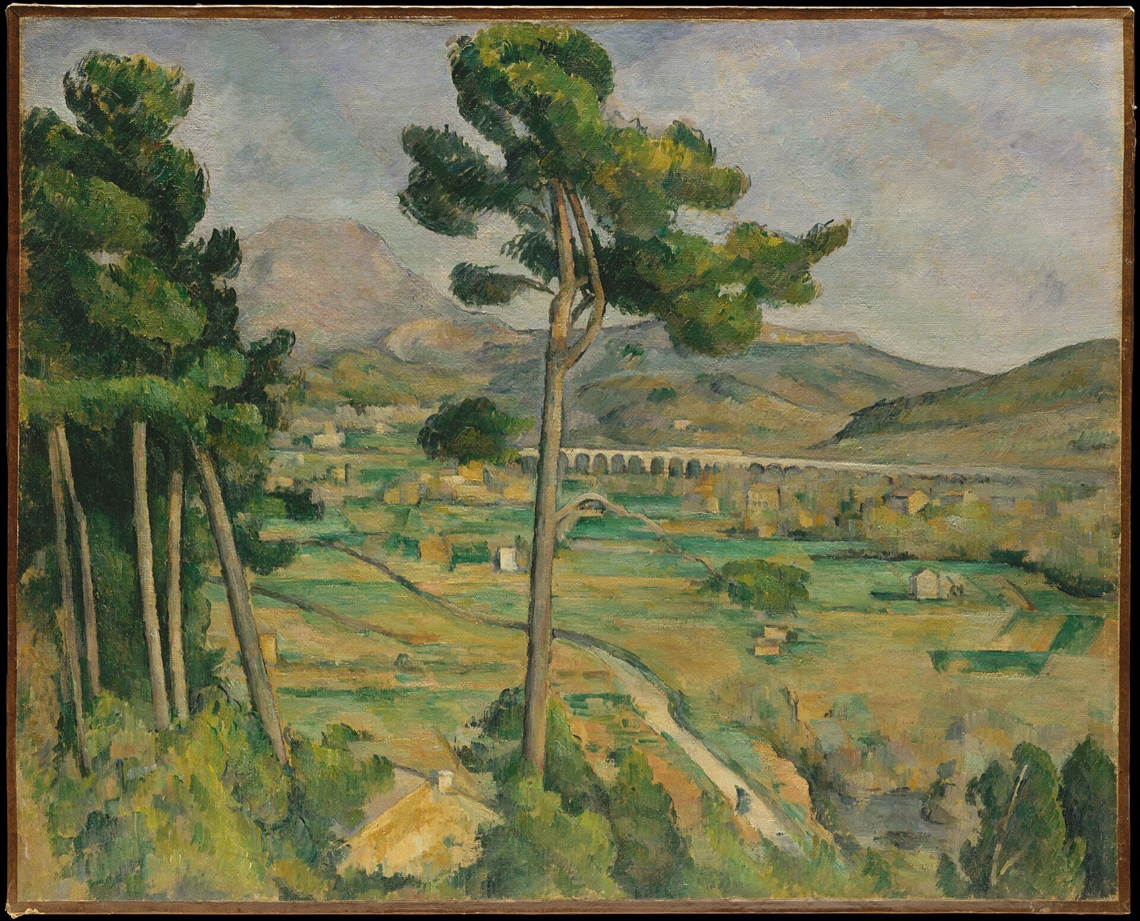 Mont Sainte-Victoire and the Viaduct of the Arc River Valley, by Cézanne: the mountain across a wide valley, with a pine trunk rising through the middle of the view.