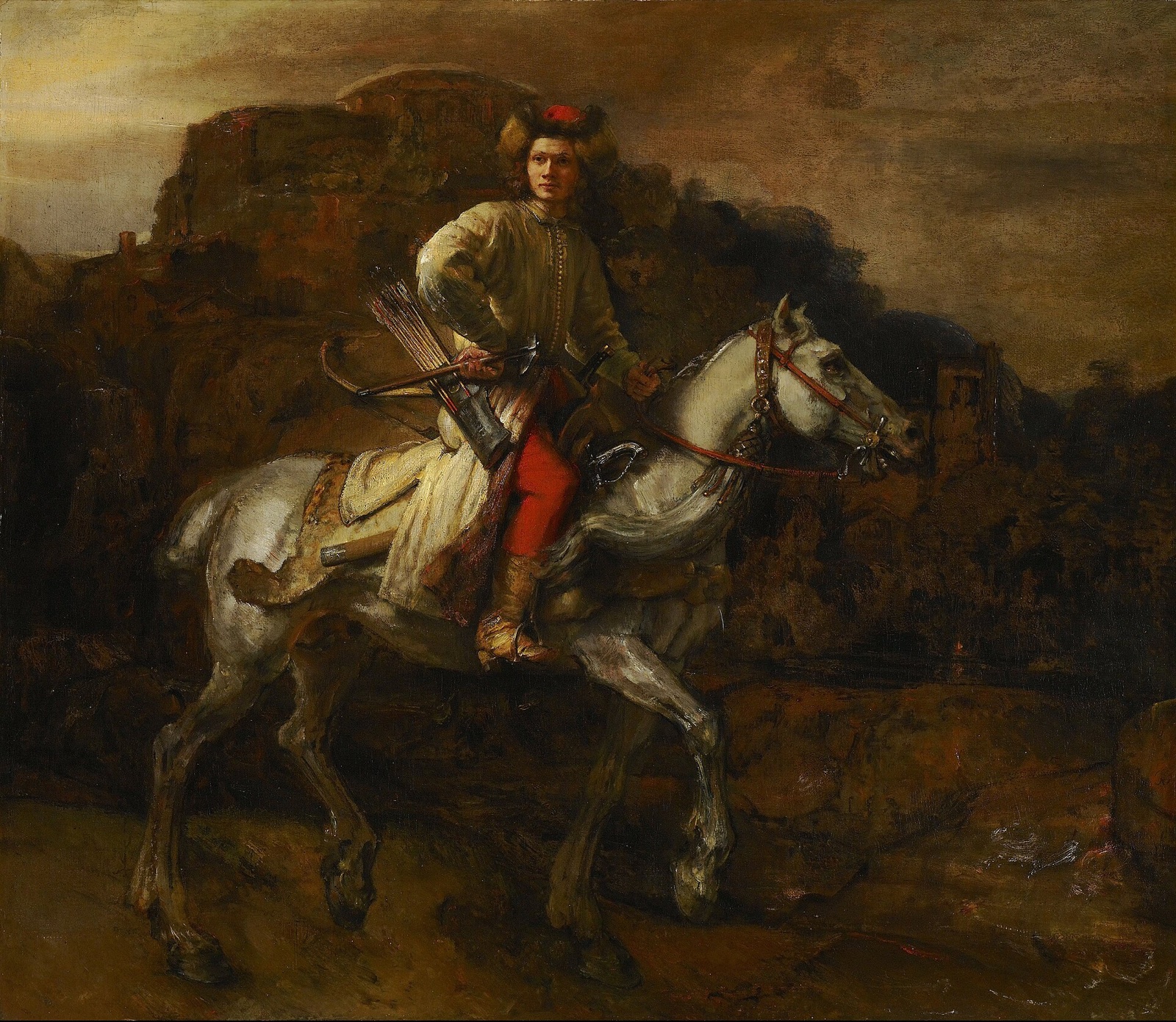 The Polish Rider, by Rembrandt: a young horseman in a fur cap rides through a dark landscape and looks out at us.