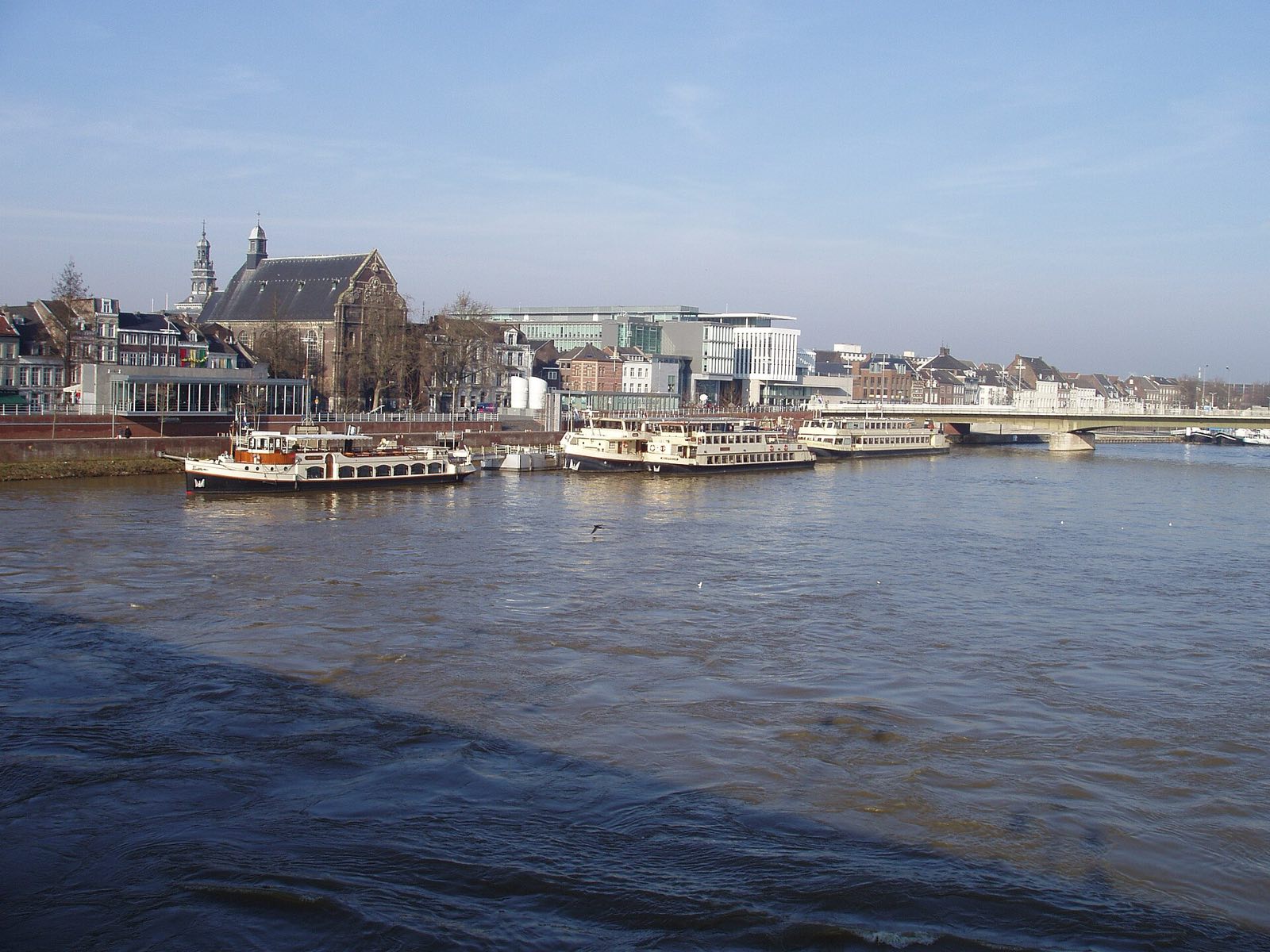 Boats on the river Maas in Maastricht, with the old town behind.