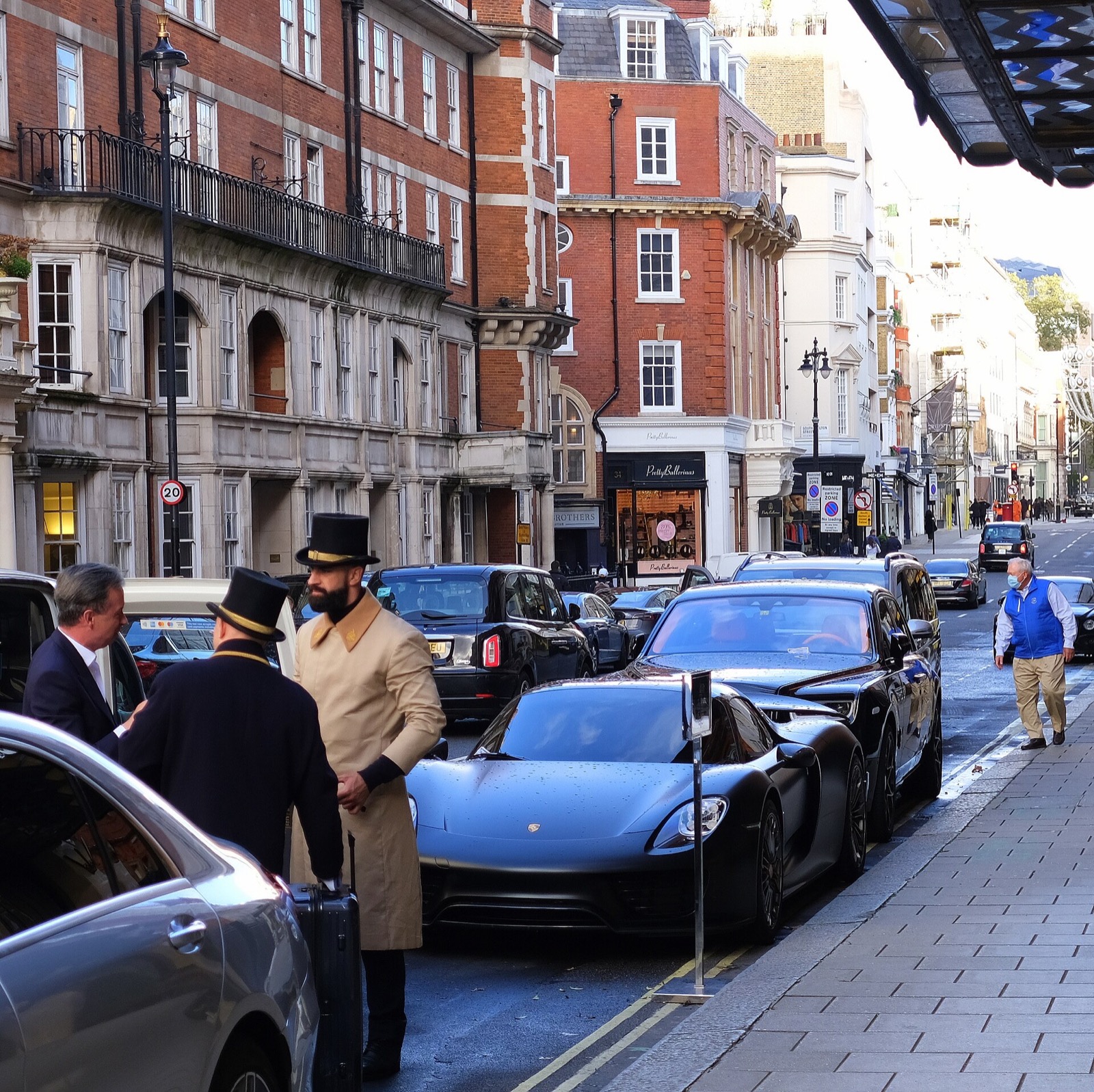 Doormen in top hats and long coats outside Claridge's.