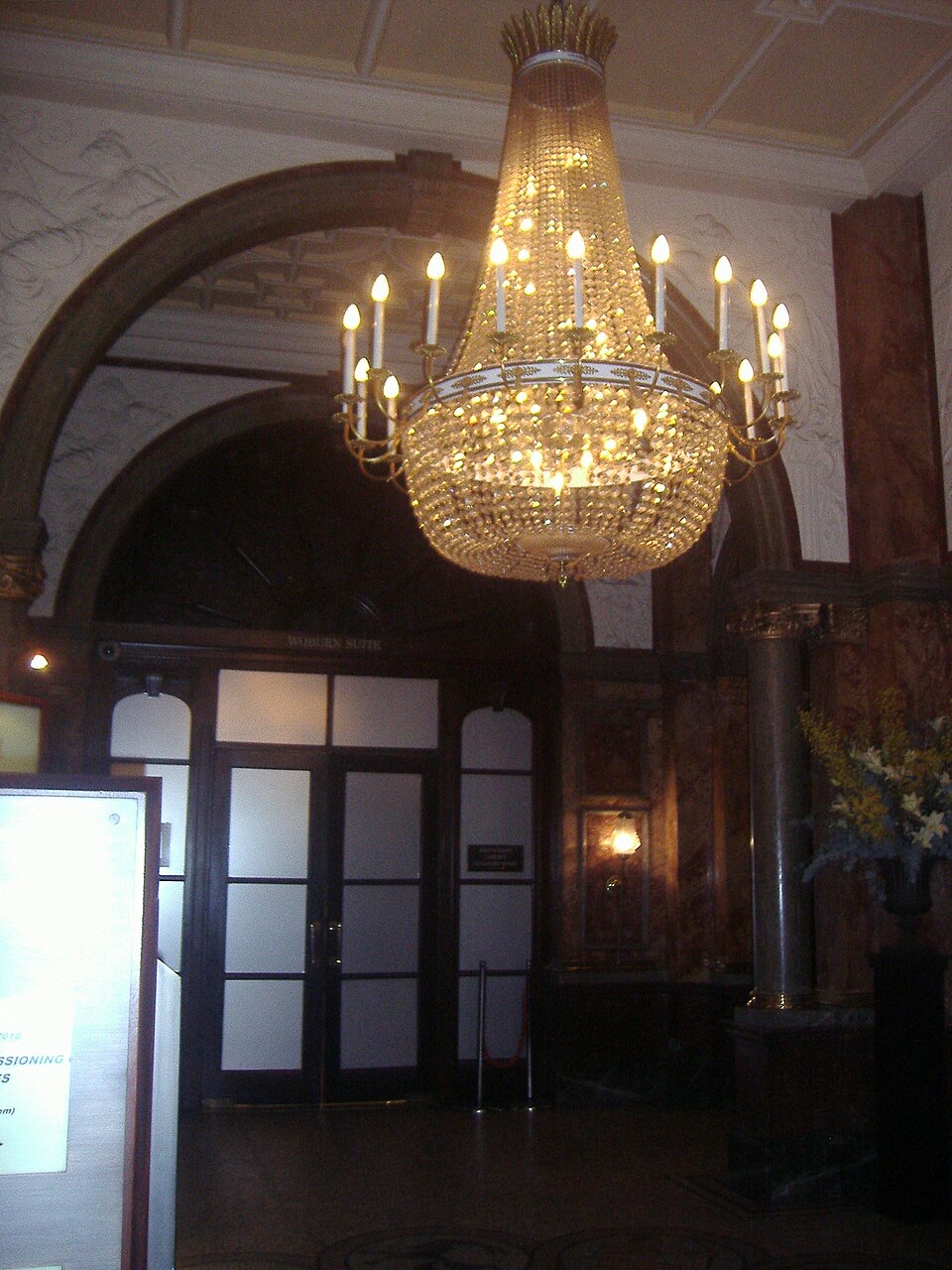 A chandelier in the marble foyer of the Kimpton Fitzroy London.