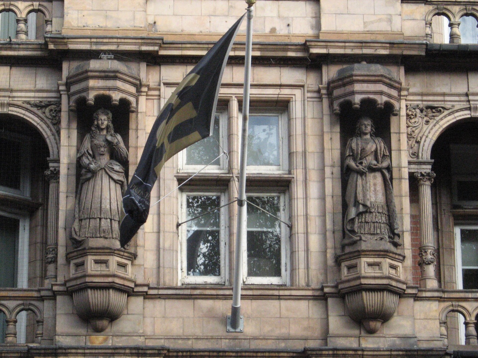 Statues of English queens in niches on the front of the Kimpton Fitzroy London.
