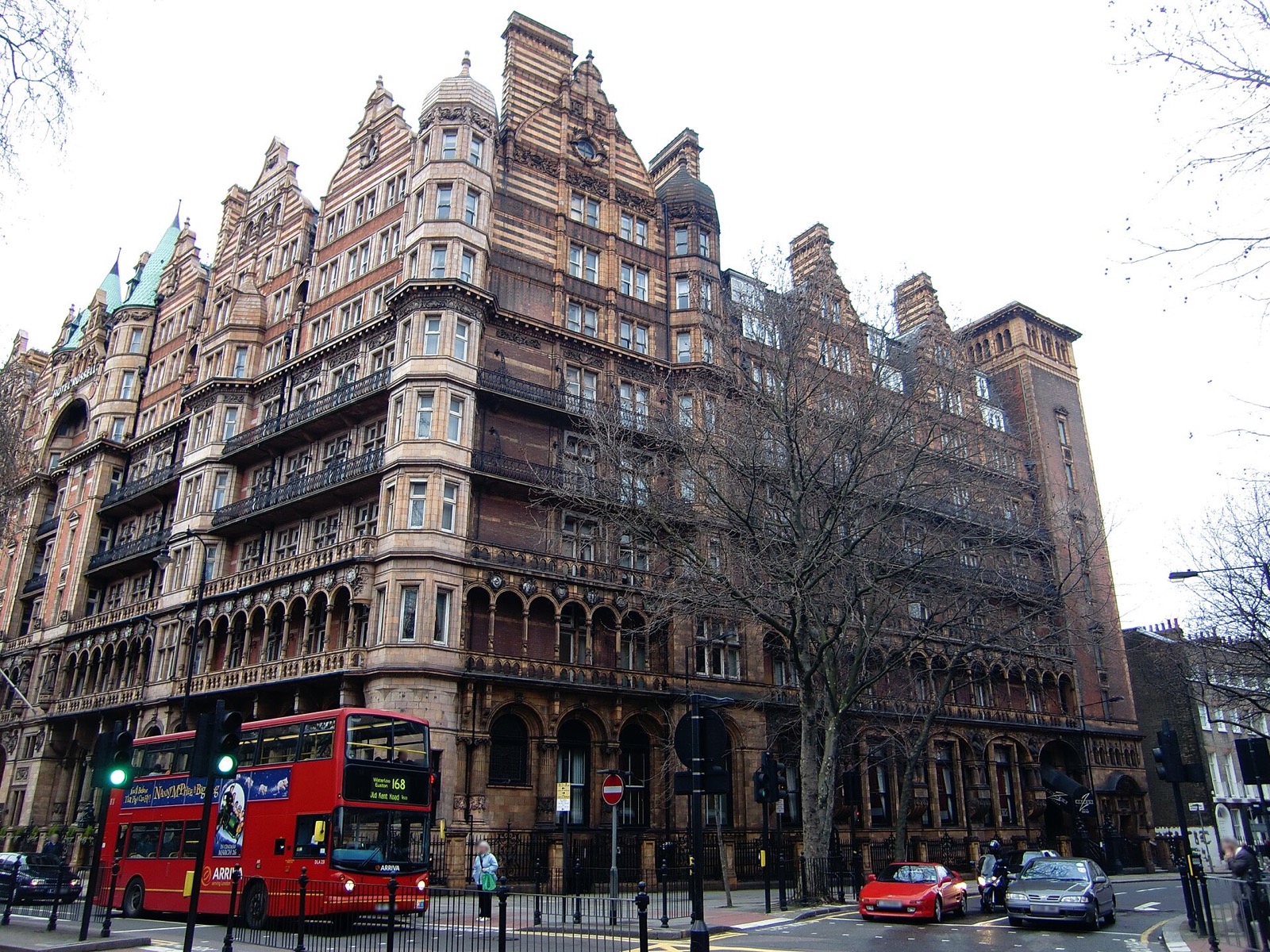 The Kimpton Fitzroy London, once the Hotel Russell, with a red London bus passing.