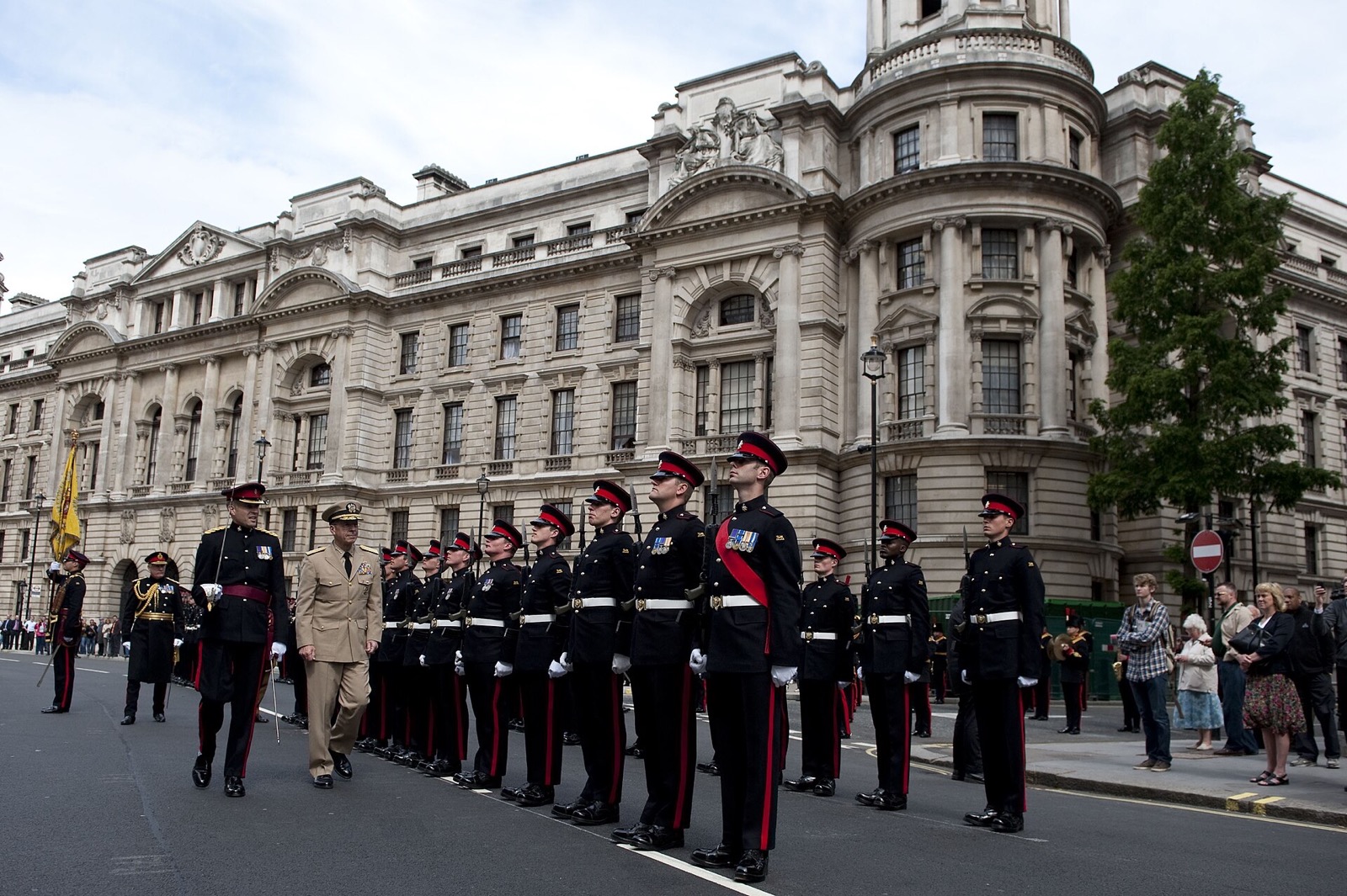Soldiers in dress uniform drawn up on Horse Guards Avenue in front of the Old War Office.