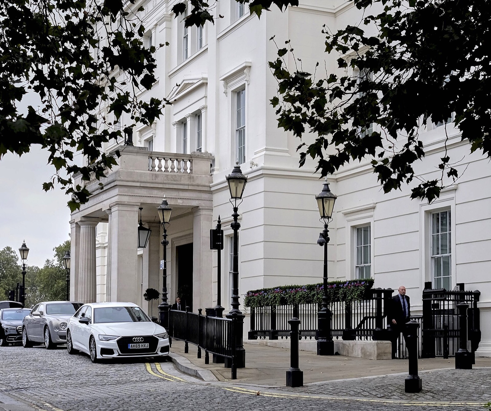 The entrance of the Lanesborough on Hyde Park Corner, a white classical portico with lamps.