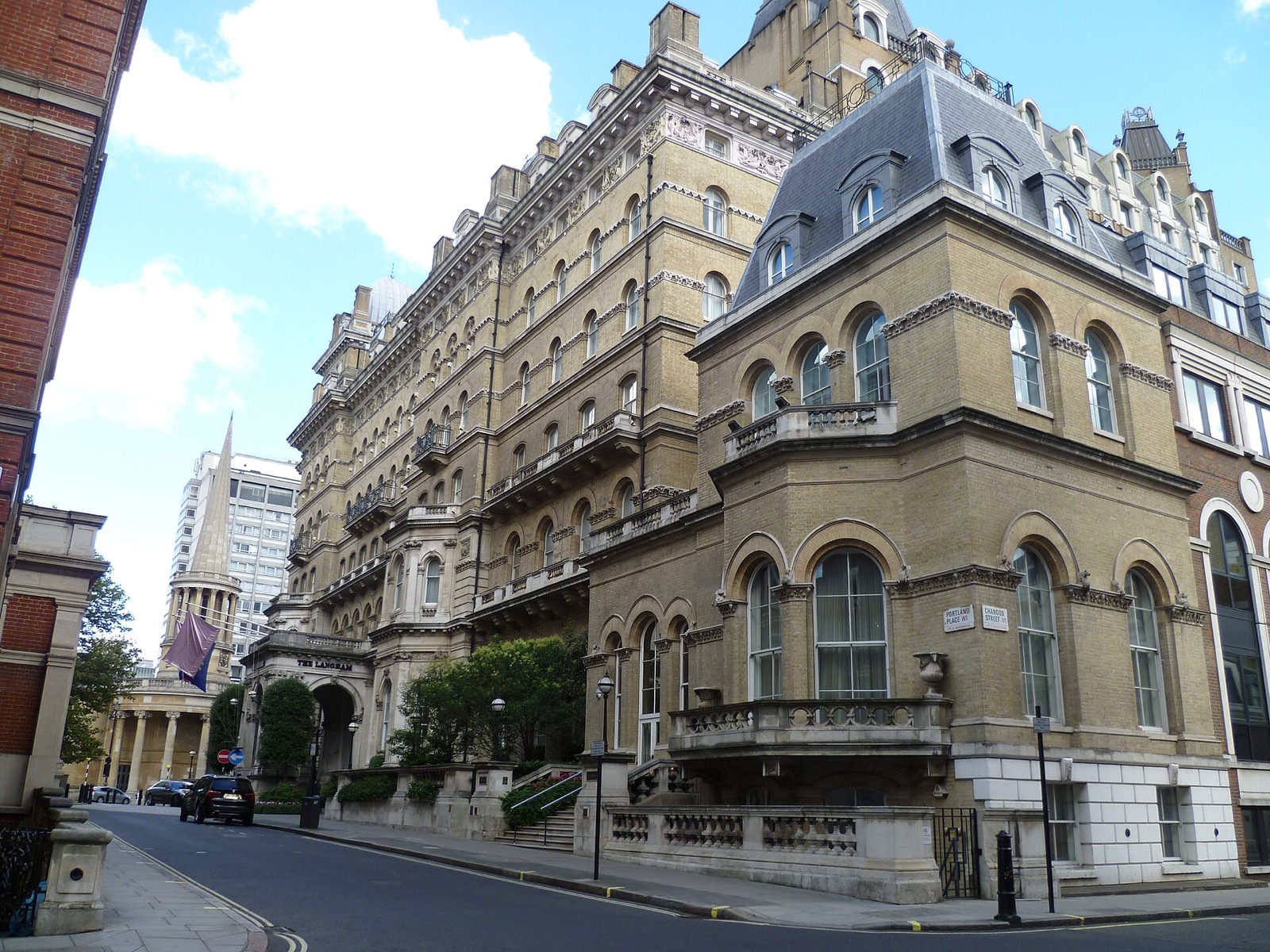The Langham on Portland Place, a Victorian hotel of pale brick and stone with a pavilion roof at the corner.