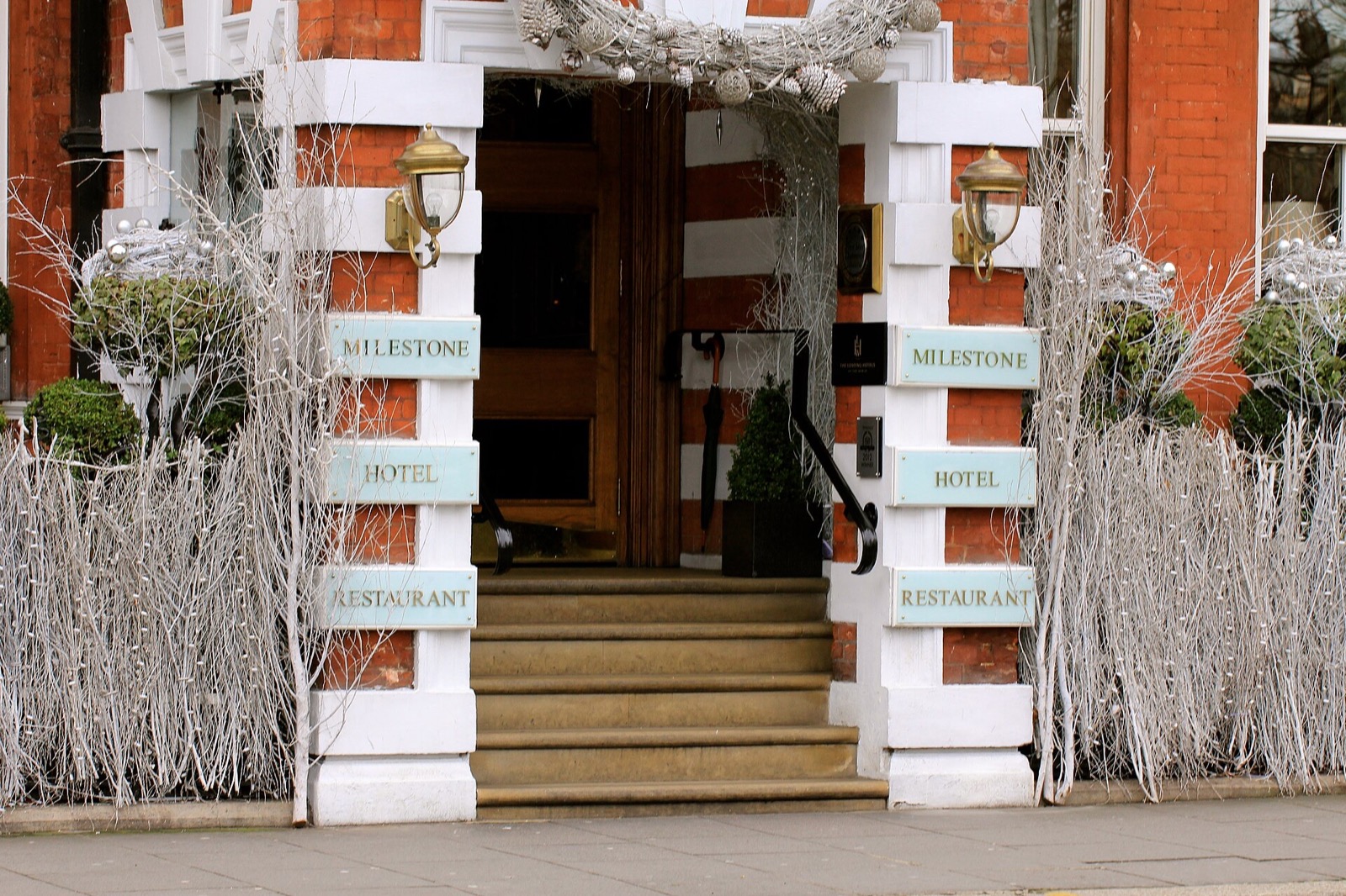 The steps and the door of the Milestone Hotel, dressed for Christmas.