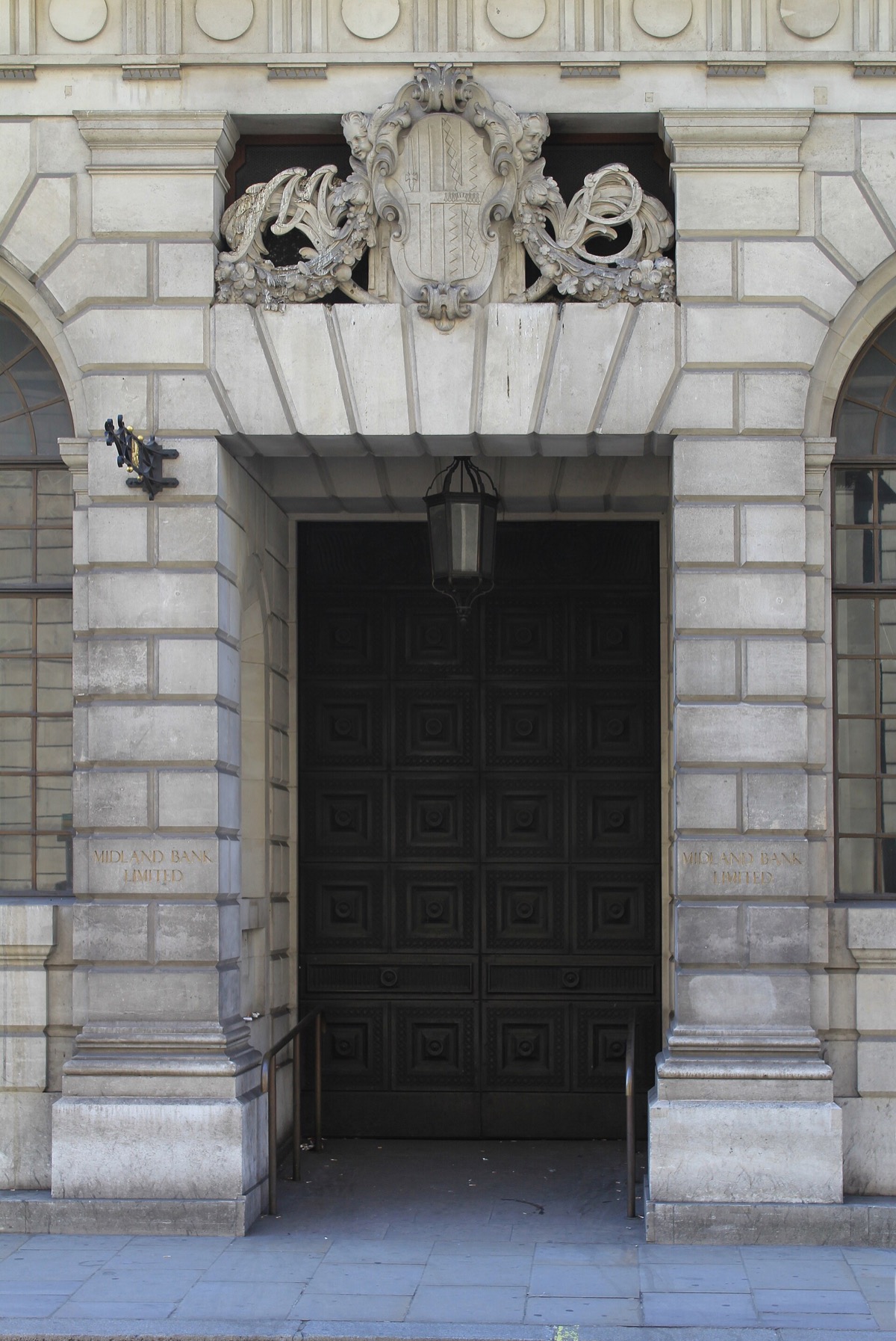 A doorway of the old Midland Bank on Poultry, under a carved stone figure.
