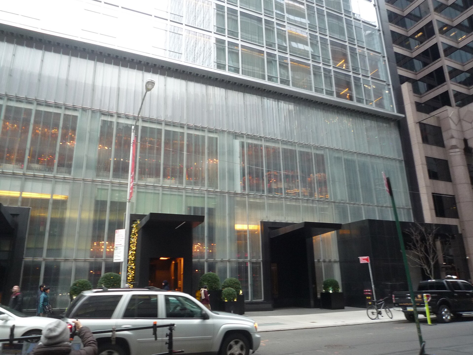 The entrance of the Baccarat Hotel on West 53rd Street, behind a wall of glass.