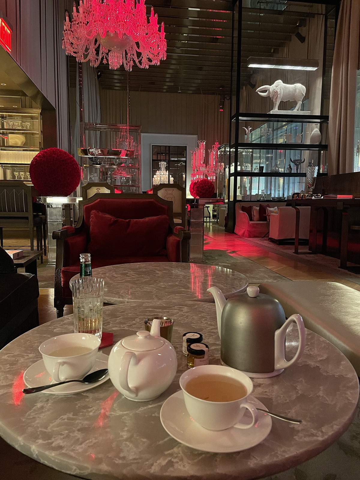 Tea in the Grand Salon of the Baccarat Hotel, under red crystal chandeliers.