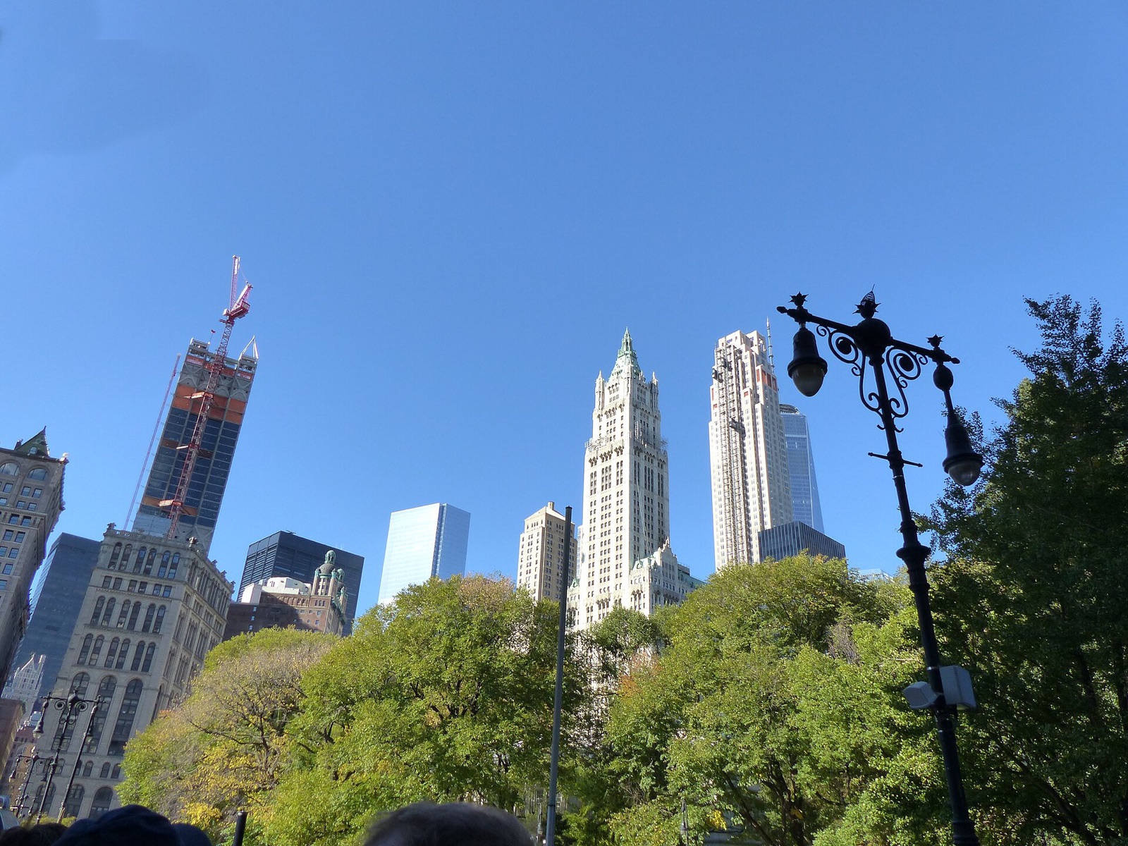 The tower at 30 Park Place nearing completion beside the Woolworth Building, seen from City Hall Park.