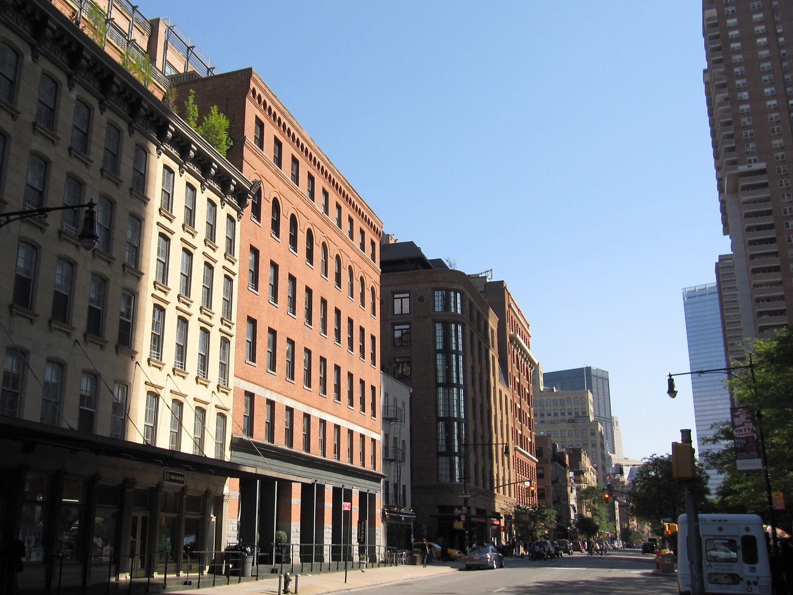 Greenwich Street in Tribeca near North Moore Street, lined with brick warehouses.