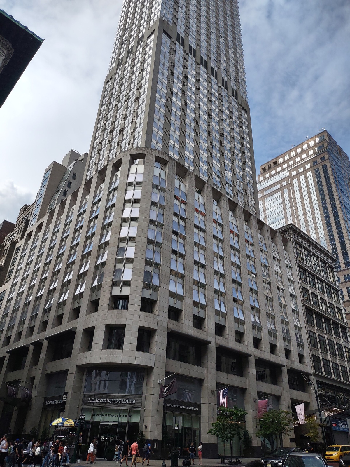 The Langham, New York, on Fifth Avenue, its limestone base under a tower of glass.