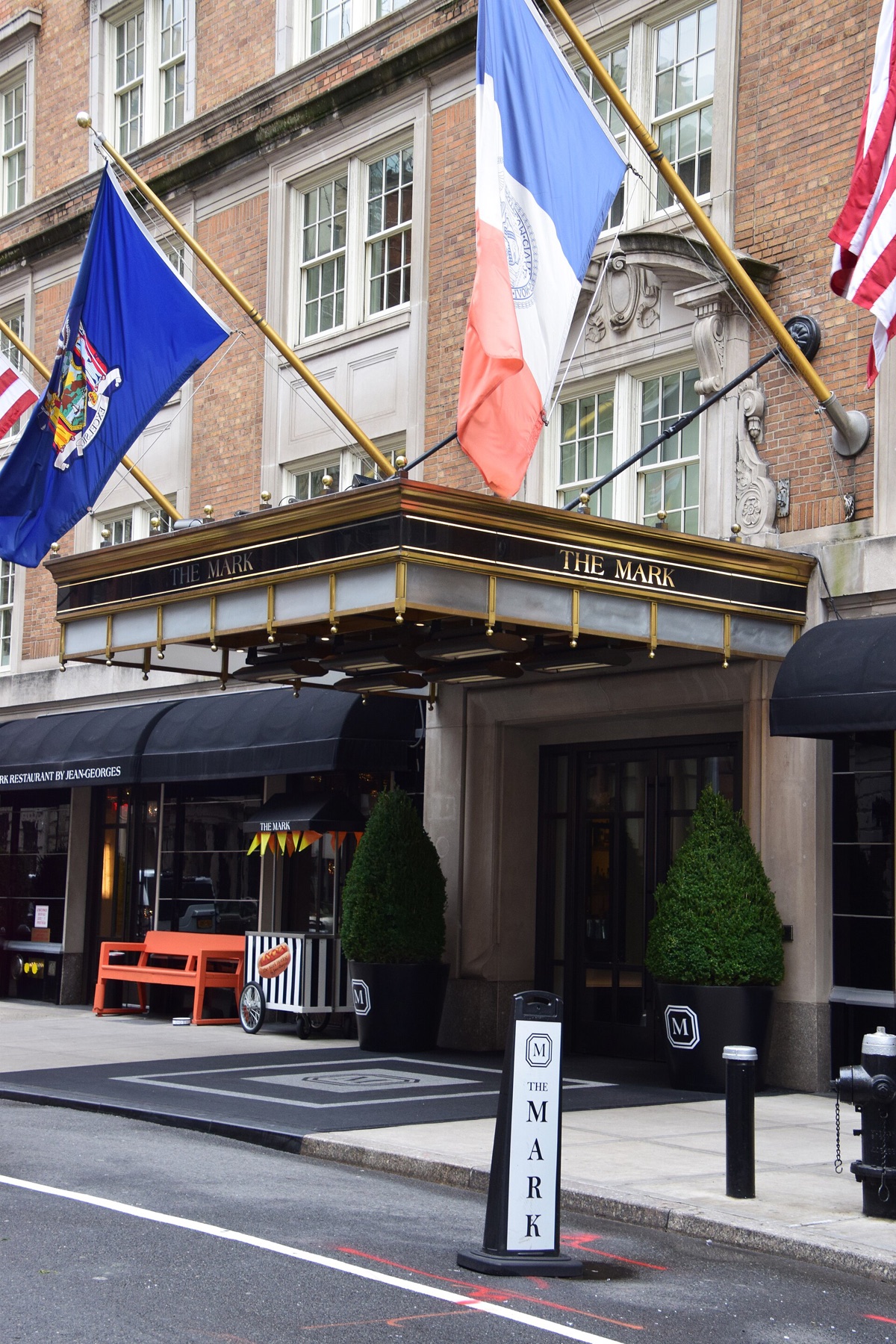 The entrance of the Mark on East 77th Street, under a striped canopy with flags above.