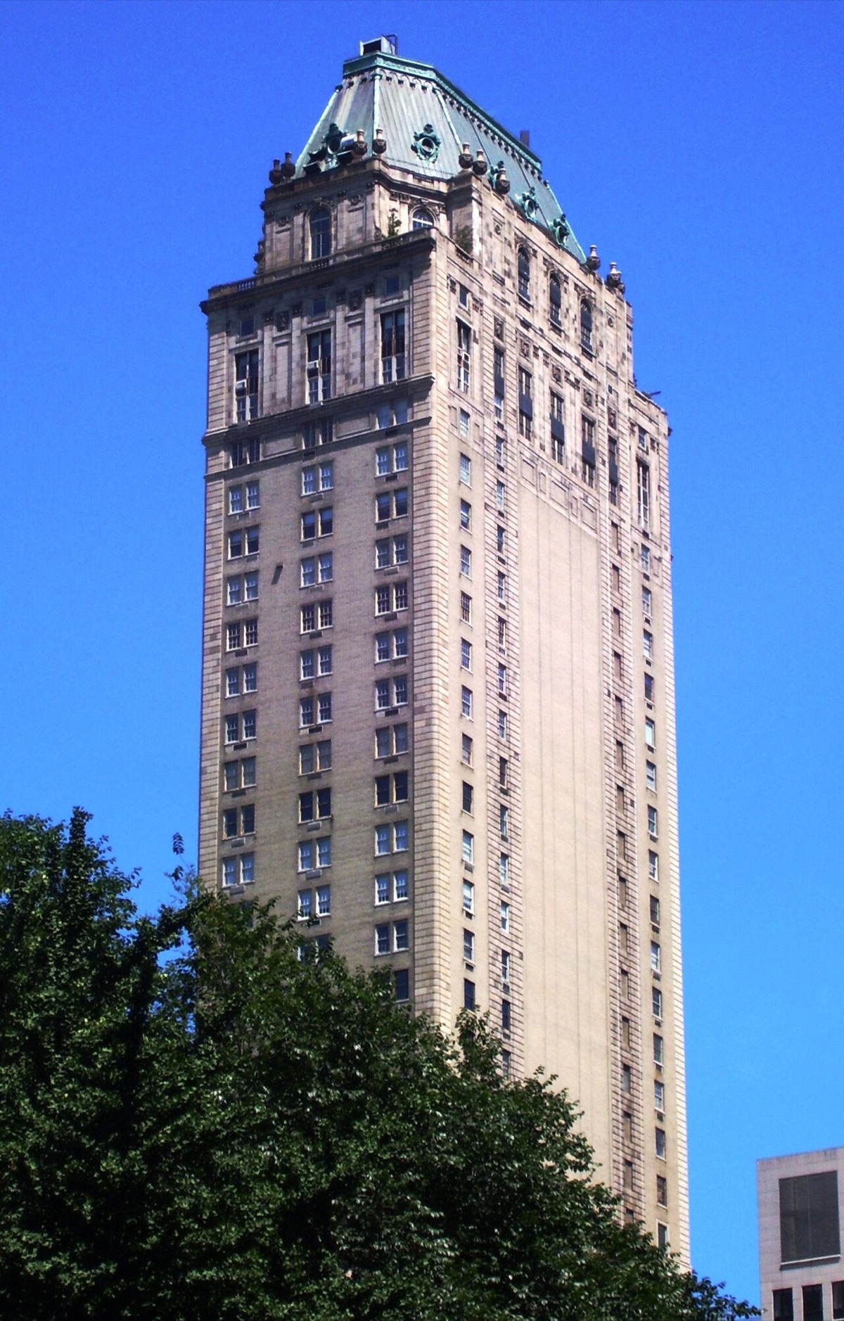 The Pierre from Central Park South, its tower of pale brick ending in a steep roof.