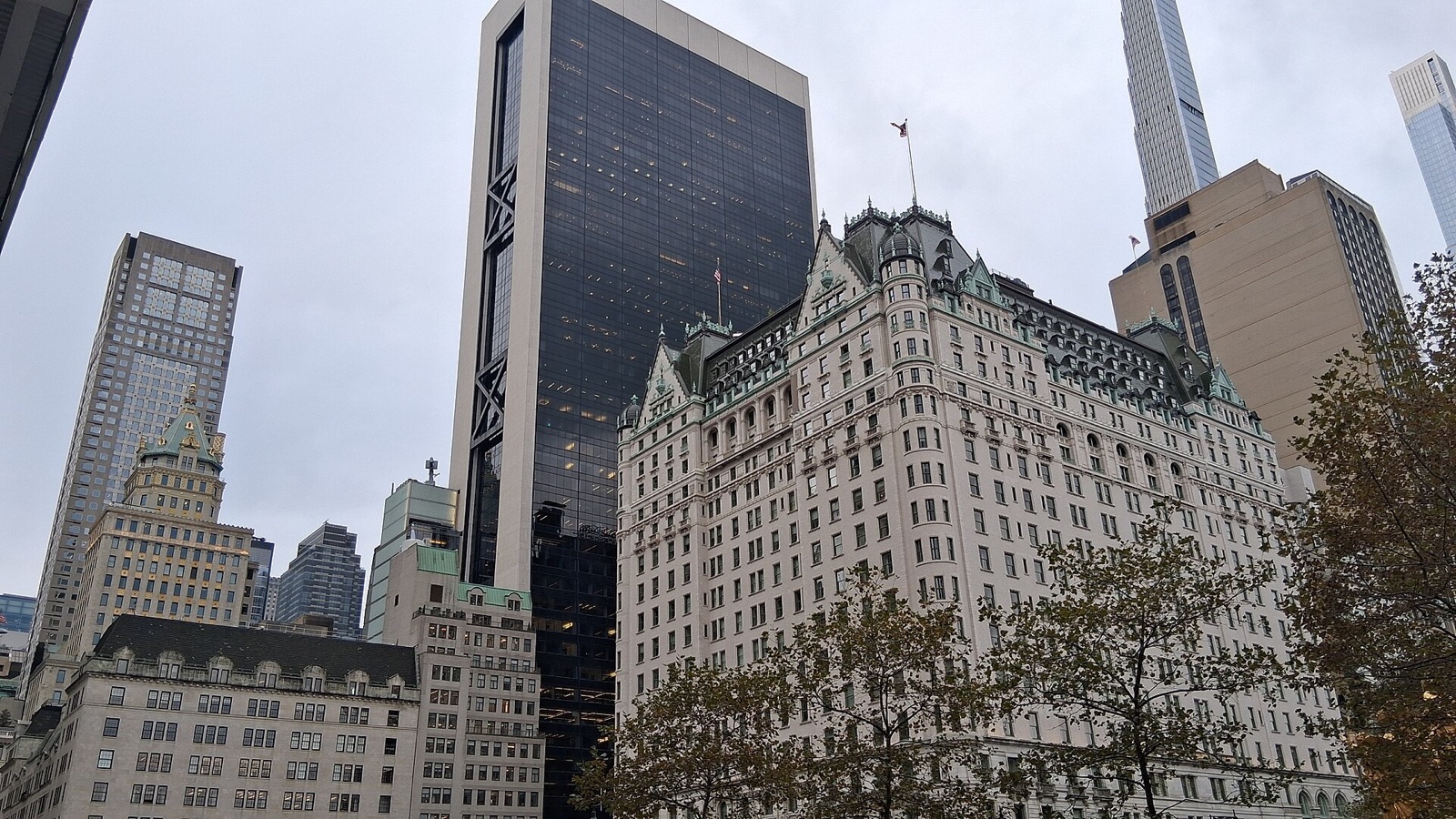 The Plaza, white under its green roof, among the towers at the corner of Central Park.