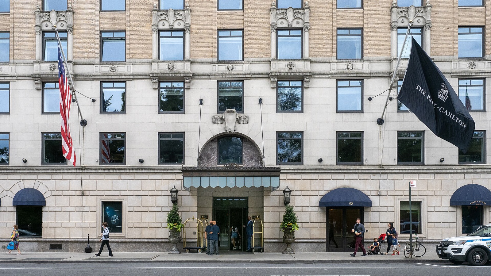 The entrance of the Ritz-Carlton on Central Park South, with flags over the awnings.