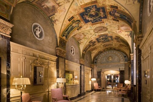 The lobby of the Sherry-Netherland, a vaulted hall with painted ceilings and marble walls.