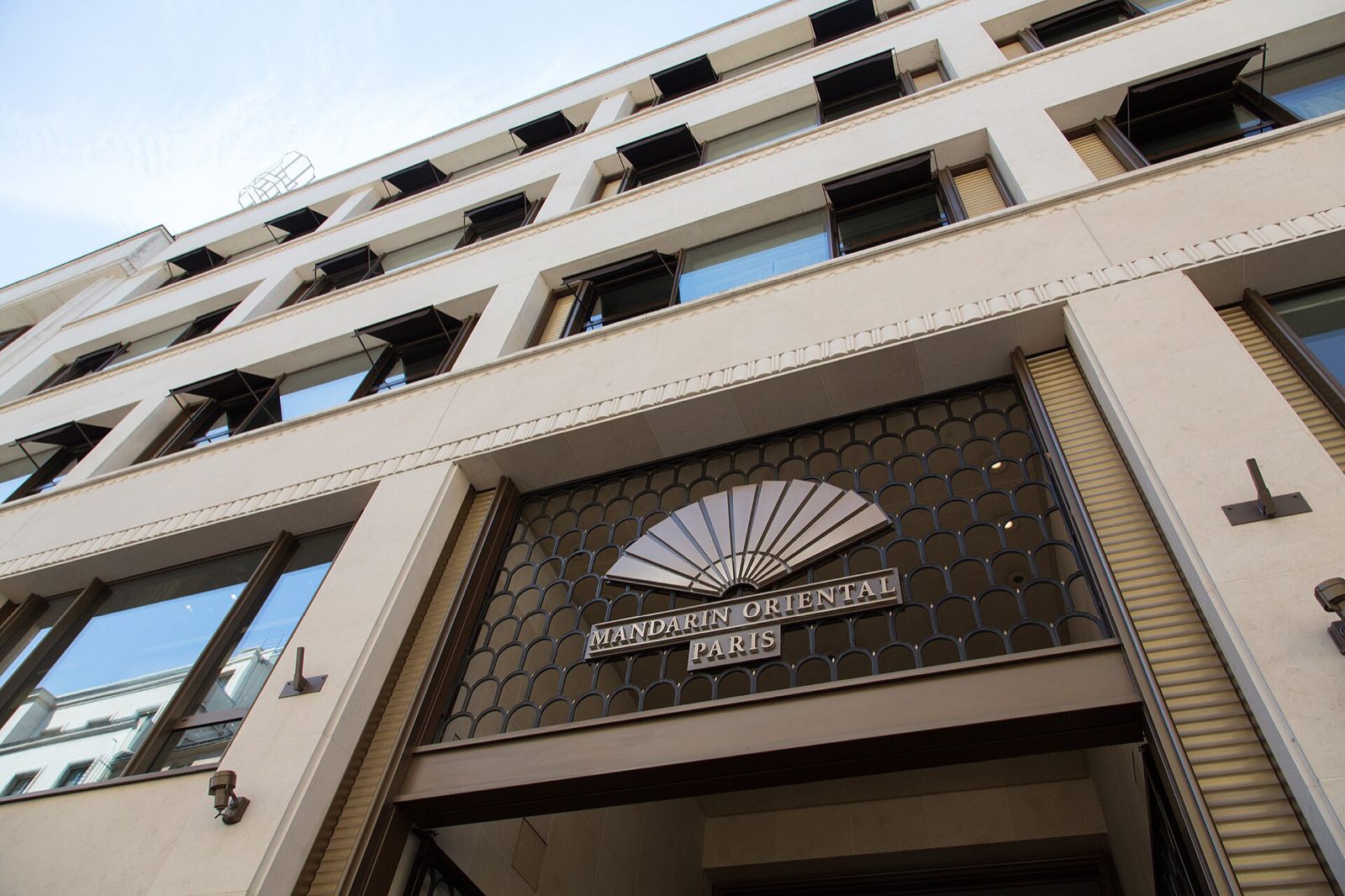 The entrance of the Mandarin Oriental on the rue Saint-Honoré, with the group's fan above the door.