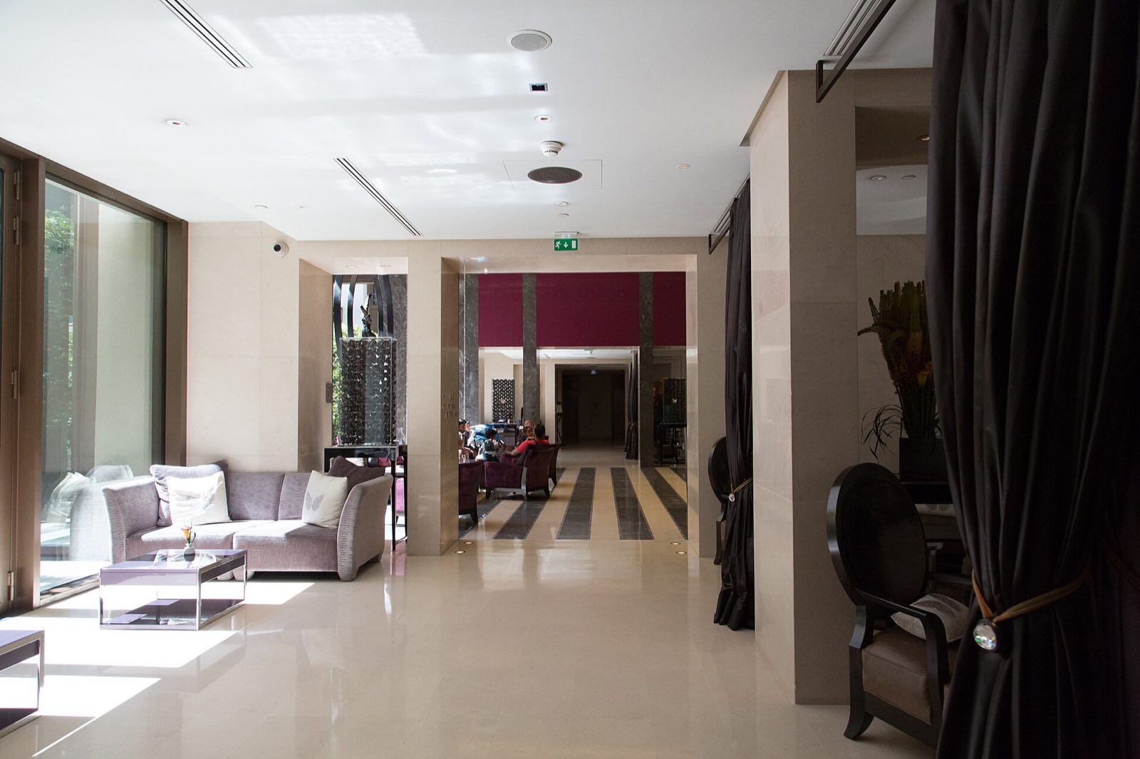 A lounge off the lobby of the Mandarin Oriental, in pale stone with low sofas.