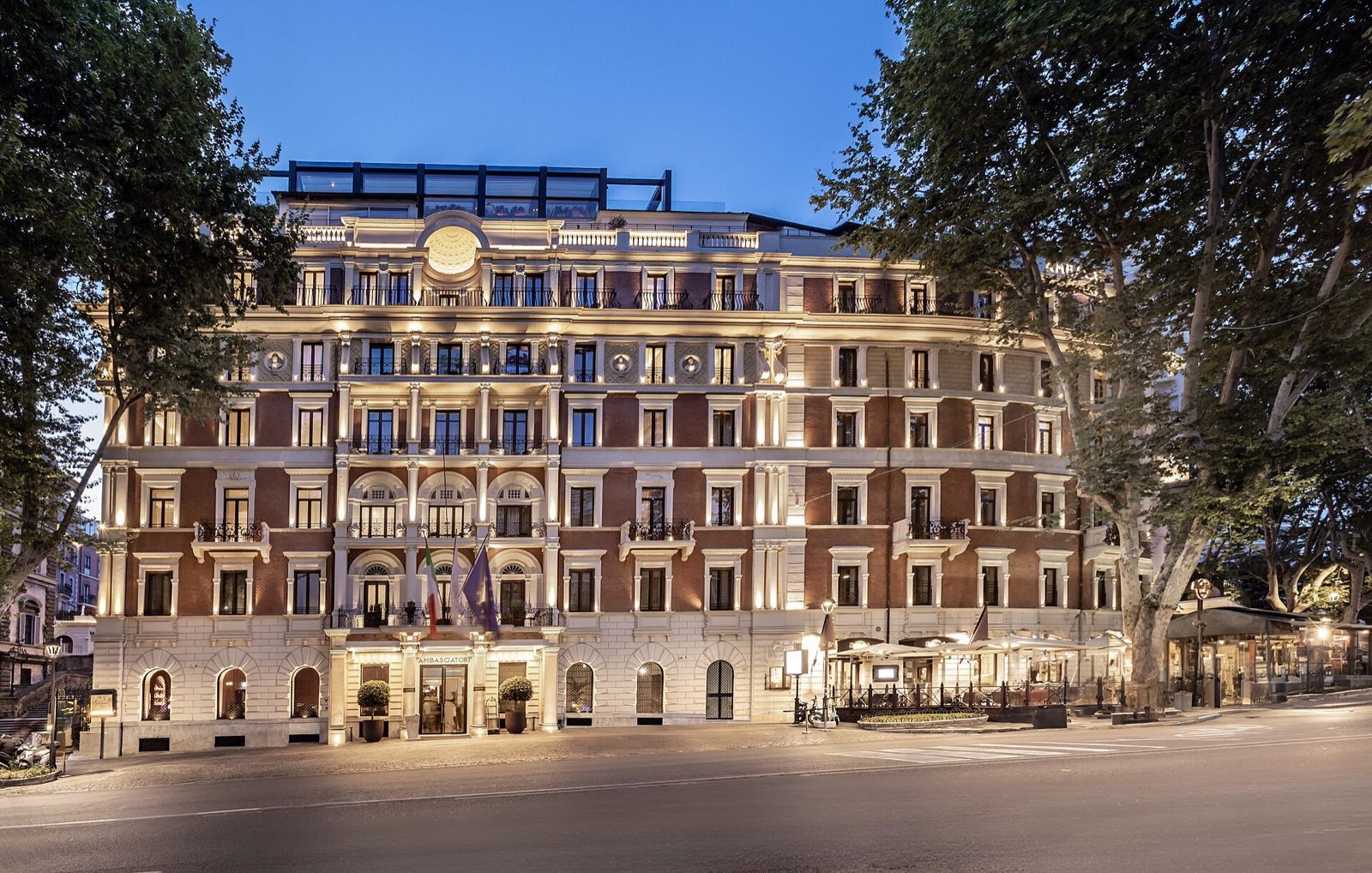 The front of the InterContinental Rome Ambasciatori Palace on Via Veneto at dusk.