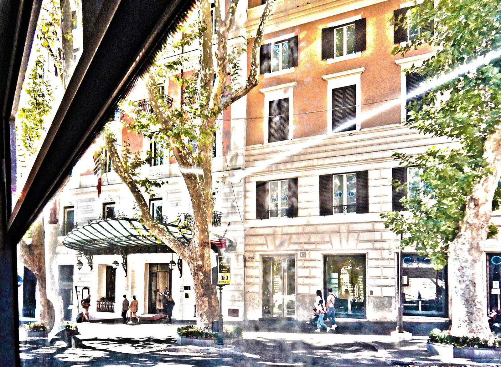The Baglioni Hotel Regina on Via Veneto, seen through the trees from across the street.