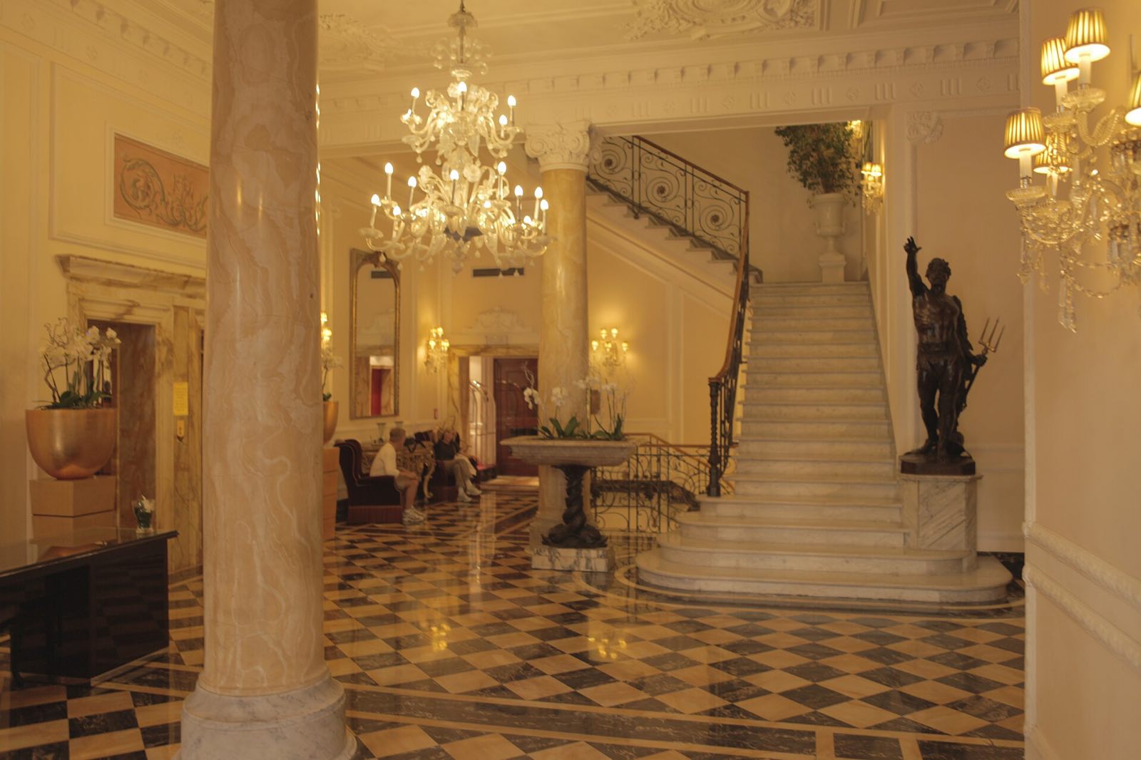 The entrance hall of the Baglioni Hotel Regina, with its marble staircase and chandelier.