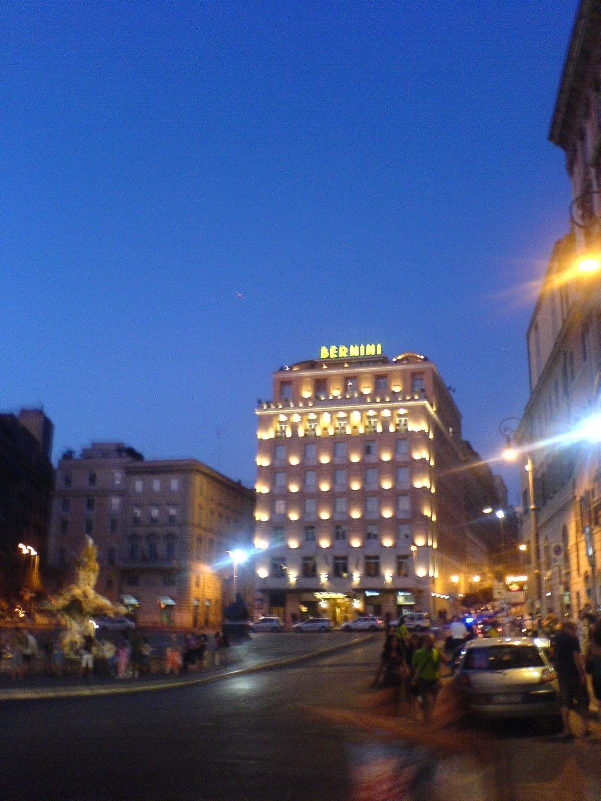 The Bernini Bristol hotel lit at night at the head of Piazza Barberini.