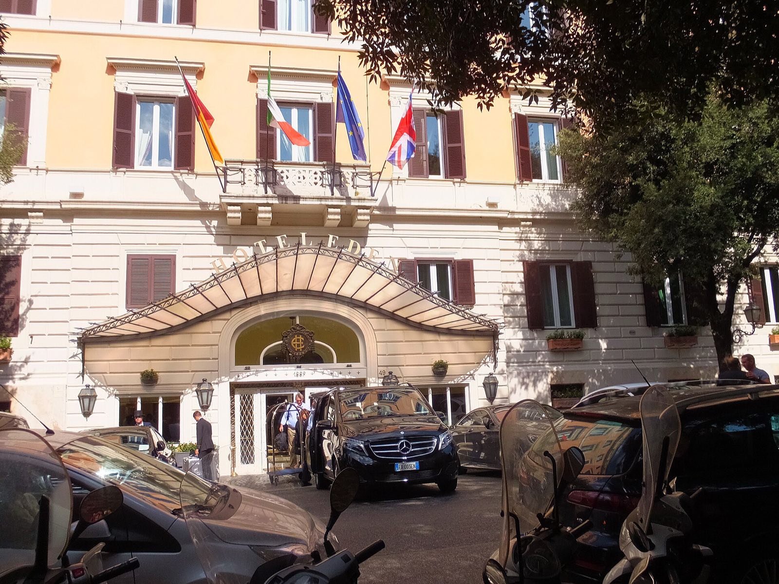 The yellow front and the glass canopy of the Hotel Eden on Via Ludovisi.