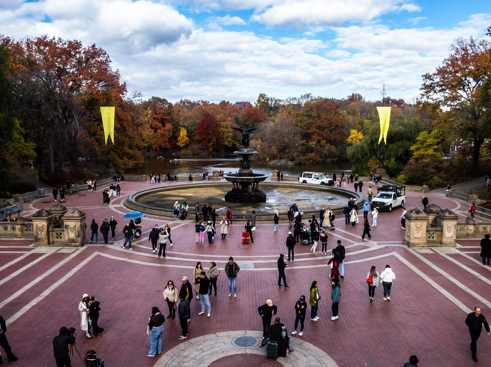 Bethesda Terrace and its fountain in Central Park, with people walking through.