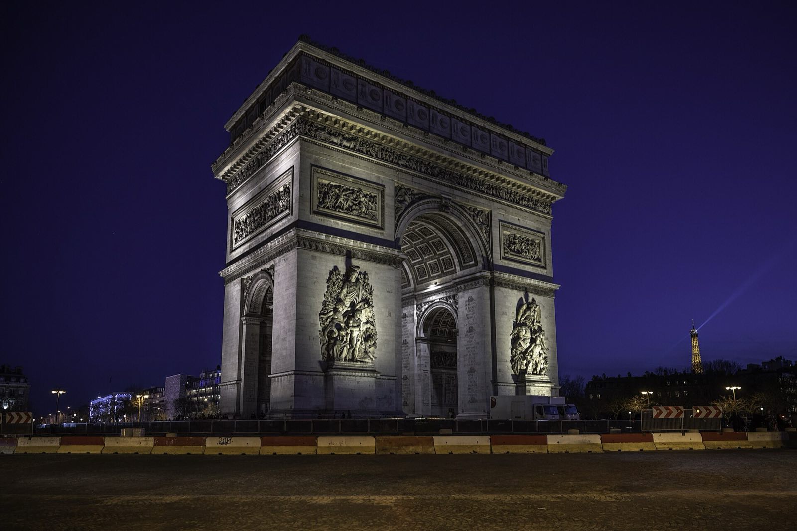 The Arc de Triomphe lit at night.