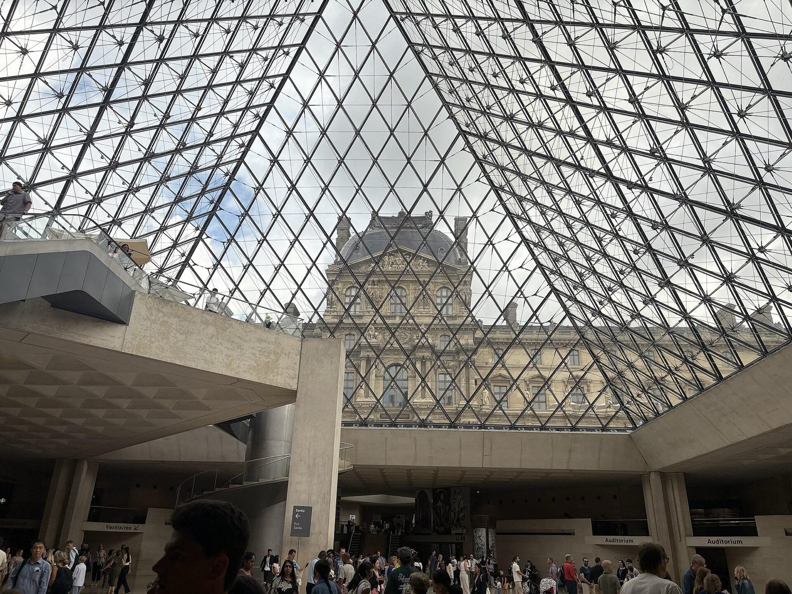 Looking up through the glass pyramid of the Louvre from the entrance hall below.