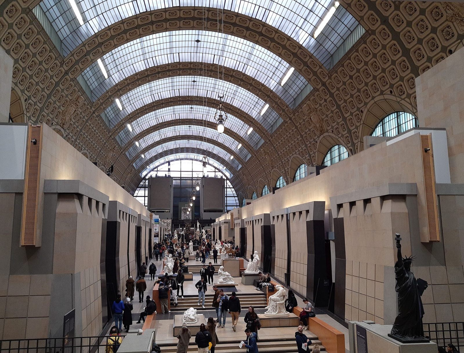 The central hall of the Musée d'Orsay under its glass roof, seen from the upper level.