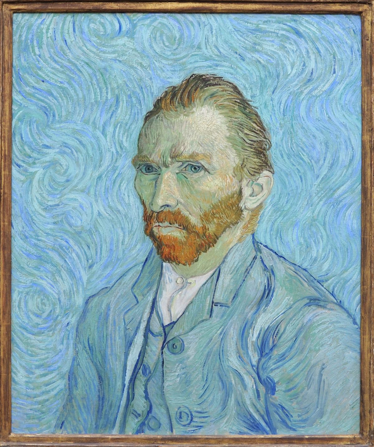 Van Gogh's self-portrait of 1889, in a pale blue suit against a swirling blue ground.