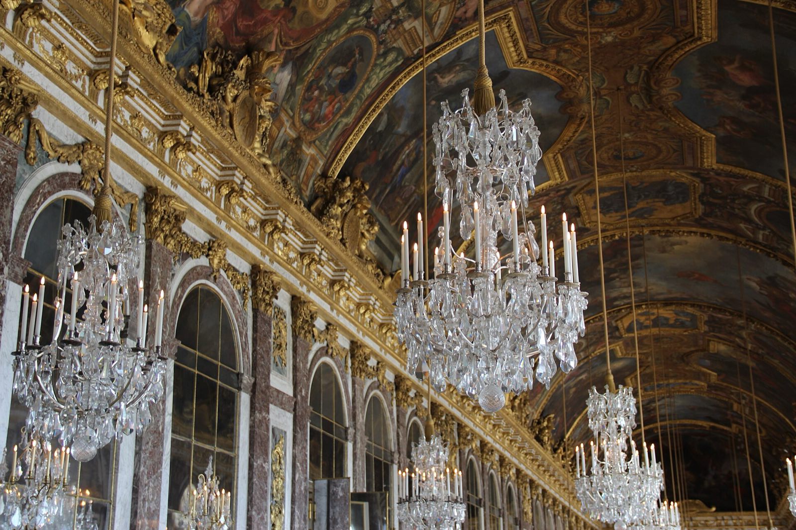 The Hall of Mirrors at the Palace of Versailles, with its chandeliers.