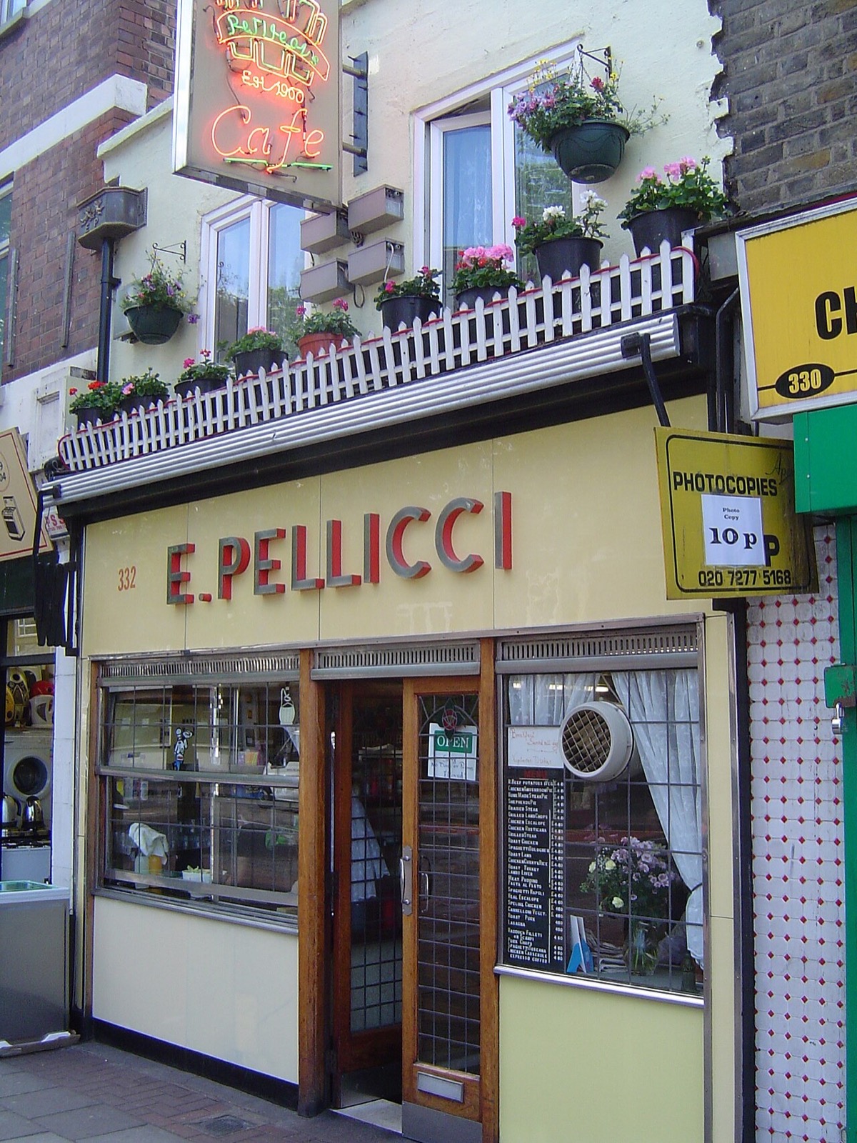 The front of E. Pellicci on Bethnal Green Road, with its name in steel letters on yellow glass.